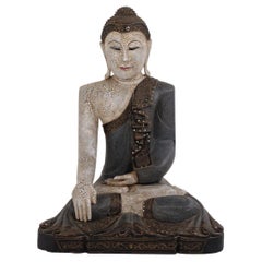Buddha figure in carved wood with light and blue-toned patina from Thailand 1920