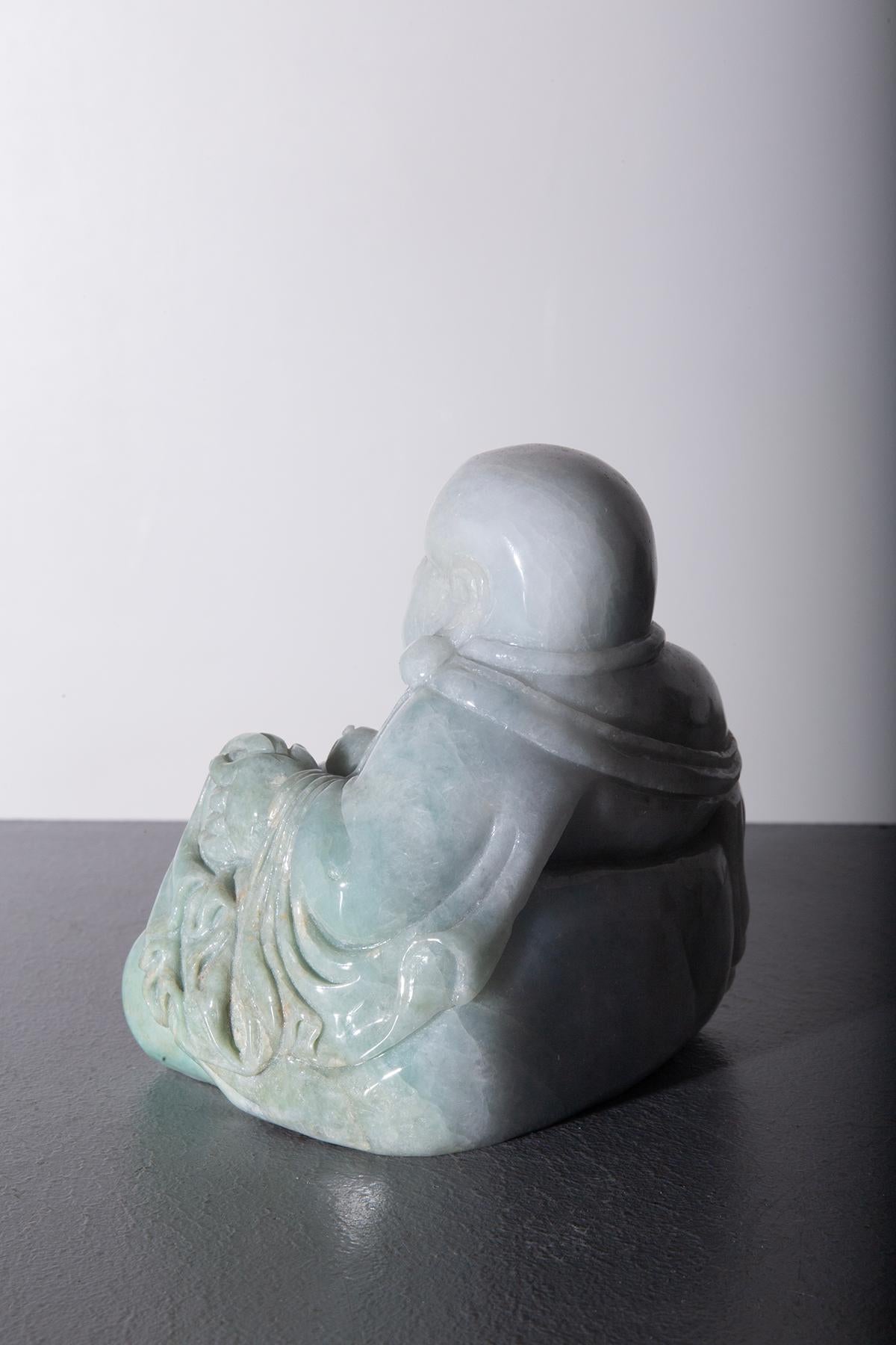 This skillfully carved Buddha in imperial jade represents one of the most iconic figures in Buddhist tradition. Imperial jade, known for its particular pale green and translucent hue, is a highly prized material, often associated with nobility,