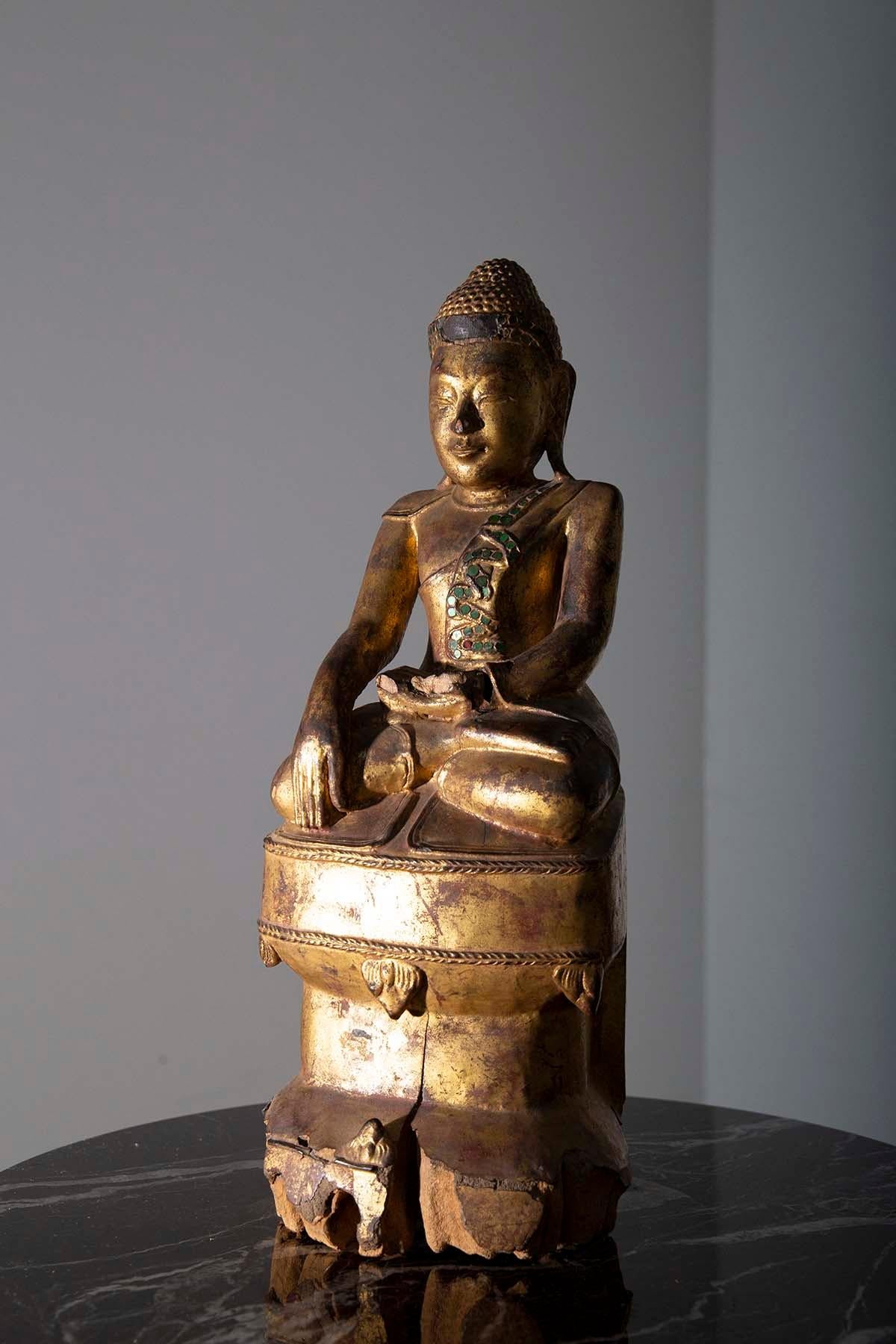In the gentle glow of your sacred space, a treasure of the ages takes its rightful place—an exquisite Buddha sculpture, hailing from the enchanting realm of Mandalay, Burma. Crafted in the 19th century, this masterpiece breathes life into the very
