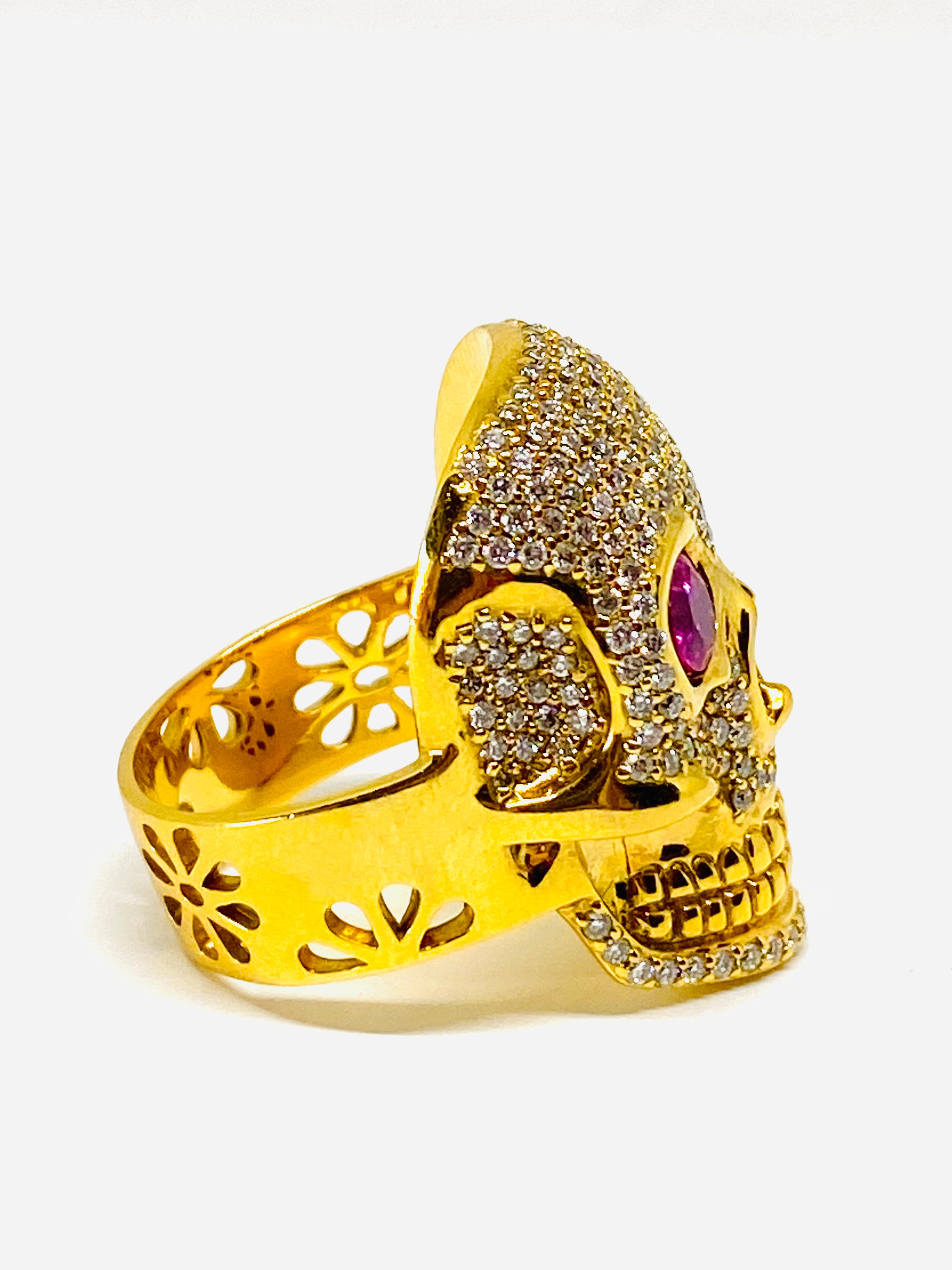 Buddha Mama 20K Yellow Gold Diamond and Pink Tourmaline Scull Coctail Ring 

Product details:
20K Yellow Gold
2ct round pink tourmaline
2ct round brilliant cut diamond, H-I/ VS2
Featuring signature flower cut out on the band of the ring and inside