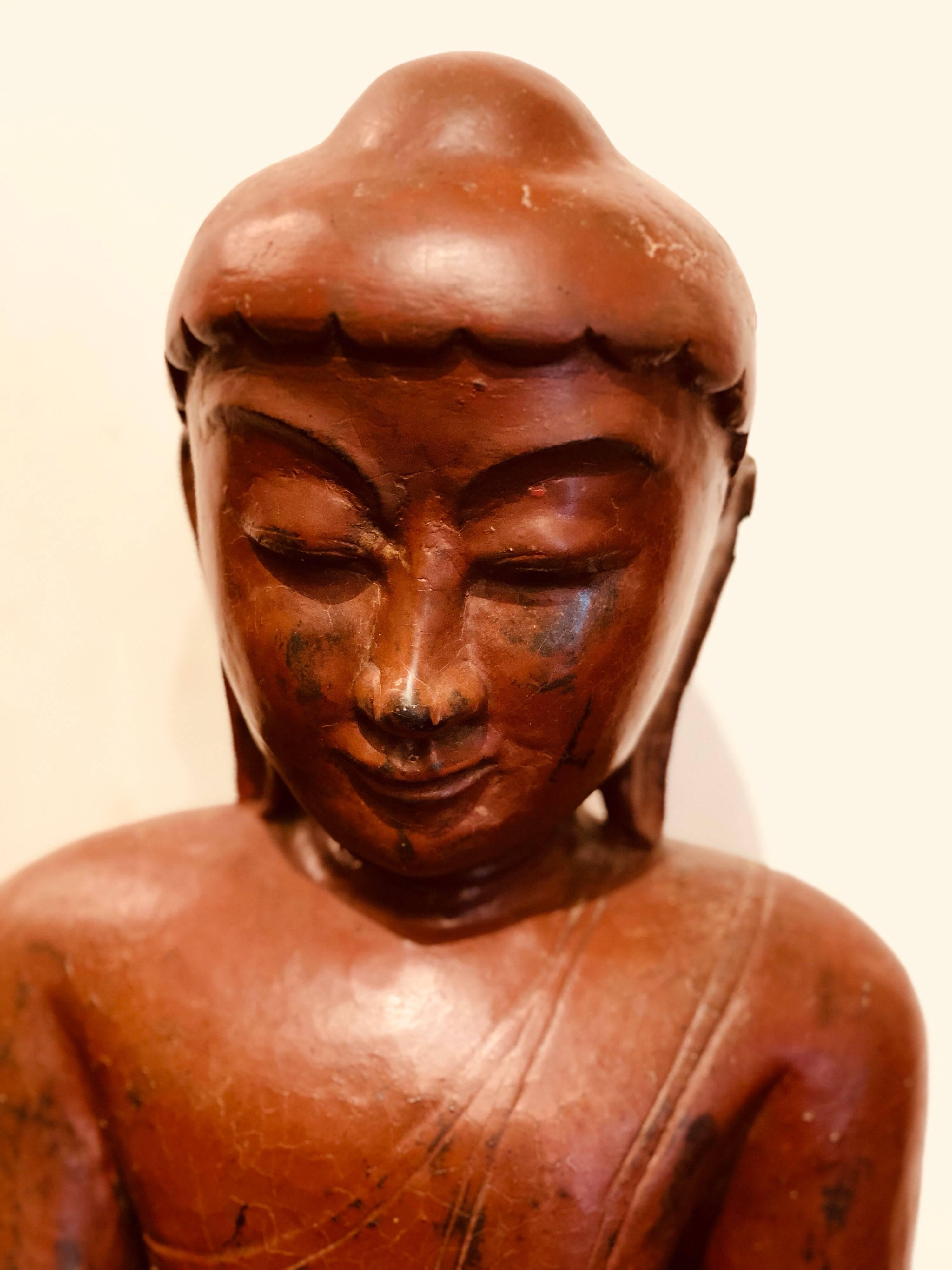 This unique red Buddha was made in Burma in the 19th century.
It is deep red with a wonderful antique texture to the material. It is made from Papier-mâché which in the 1800s was more expensive than wood to carve a Buddha from.
We love this piece