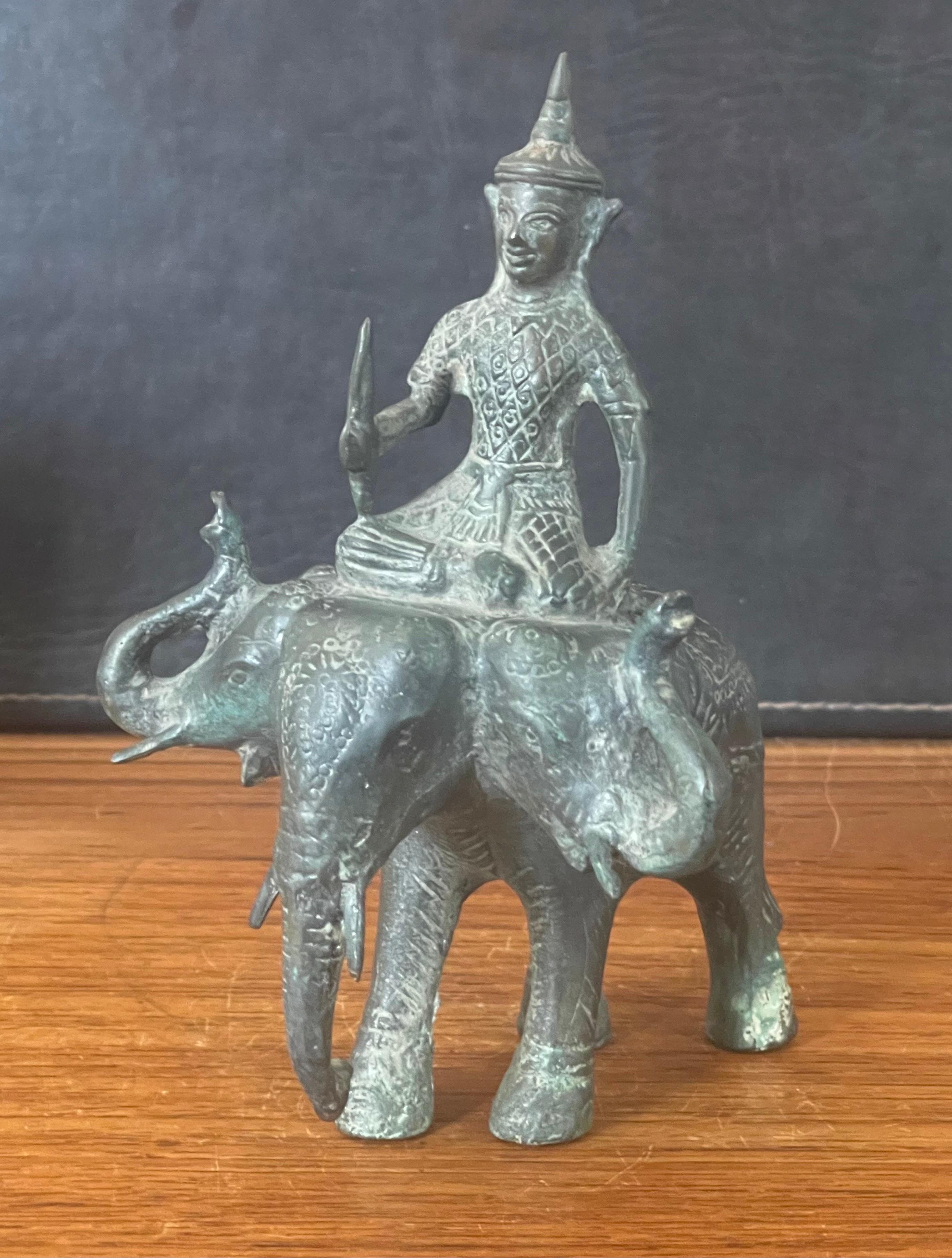 Well casted, heavy bronze, Buddha riding three headed elephant sculpture, circa 1960s. The piece depicts Indra, Hindu deity (god of rain and thunder), riding a three-headed elephant (Erawan). The piece is in very good vintage condition and measures