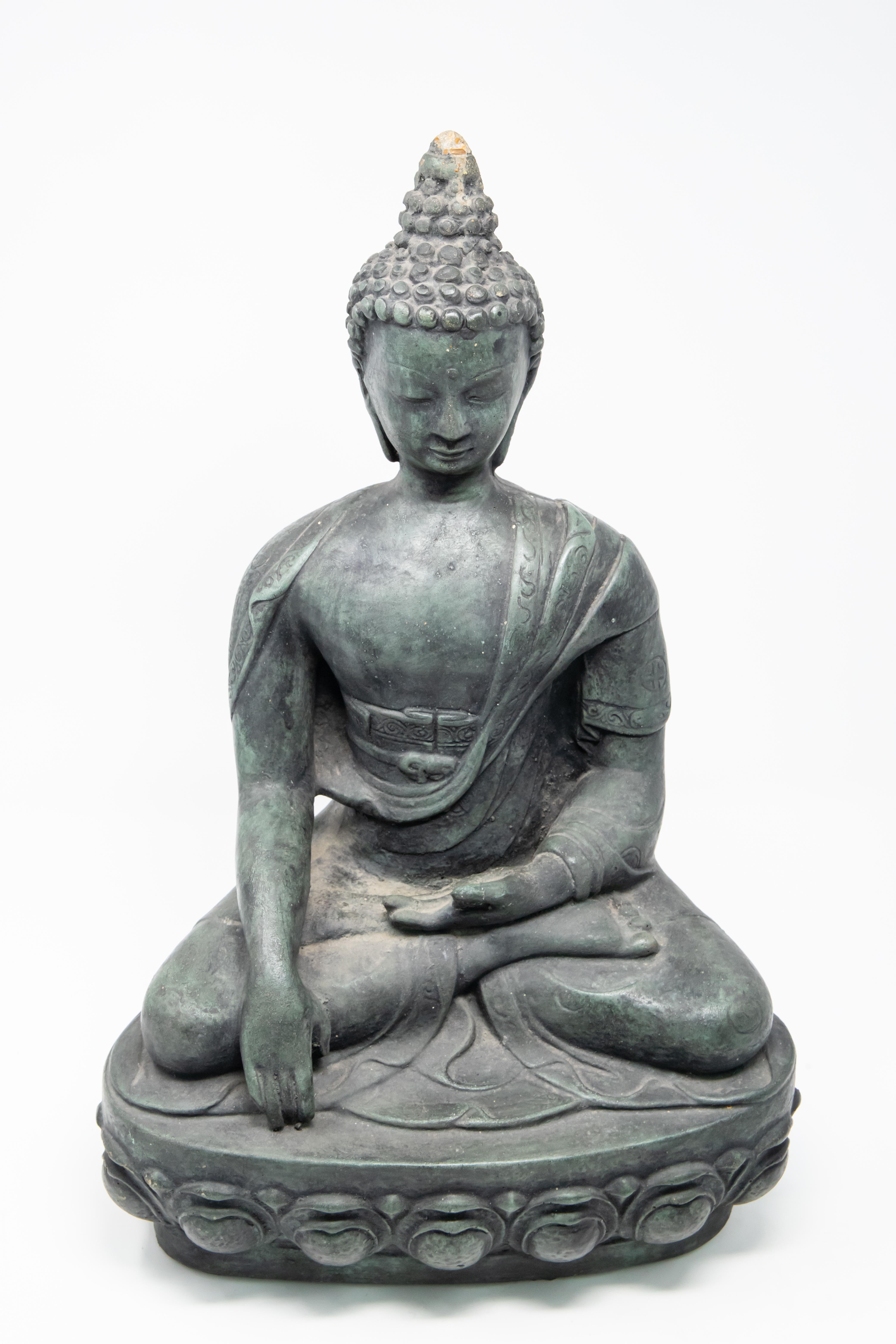 Sandstone garden statue of seated Buddha. Contemporary design makes the piece a standout in the garden or entryway. She has a beautiful aged patina that is a blue or grey color.