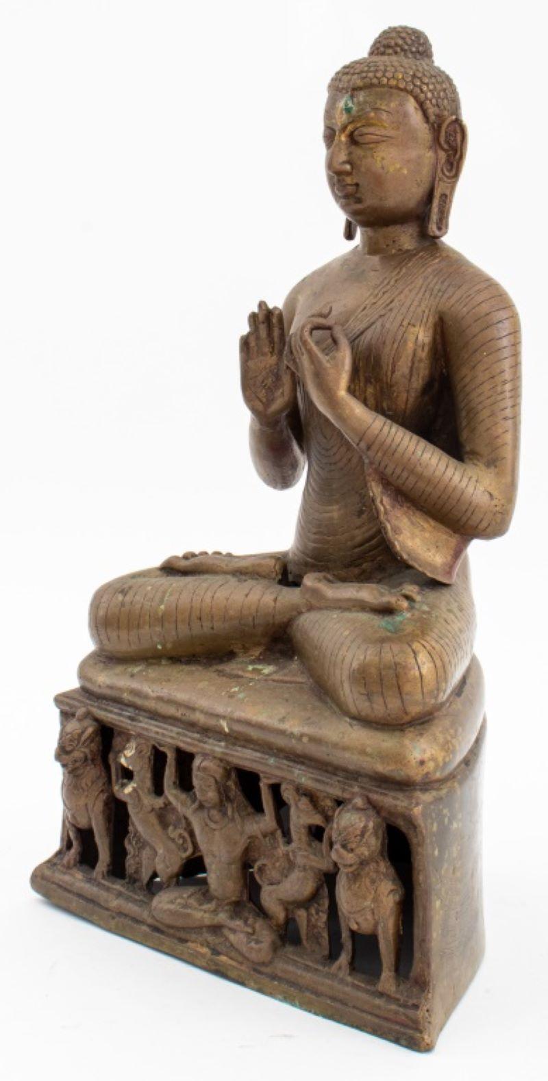 Buddha Shakyamuni or the Jina Buddha Vairochana sculpture in brass, likely Kashmiri, 19th century or later, depicting the Buddha in contemplation, on a reticulated plinth with a frieze depicting the Buddha with lions. 15.5