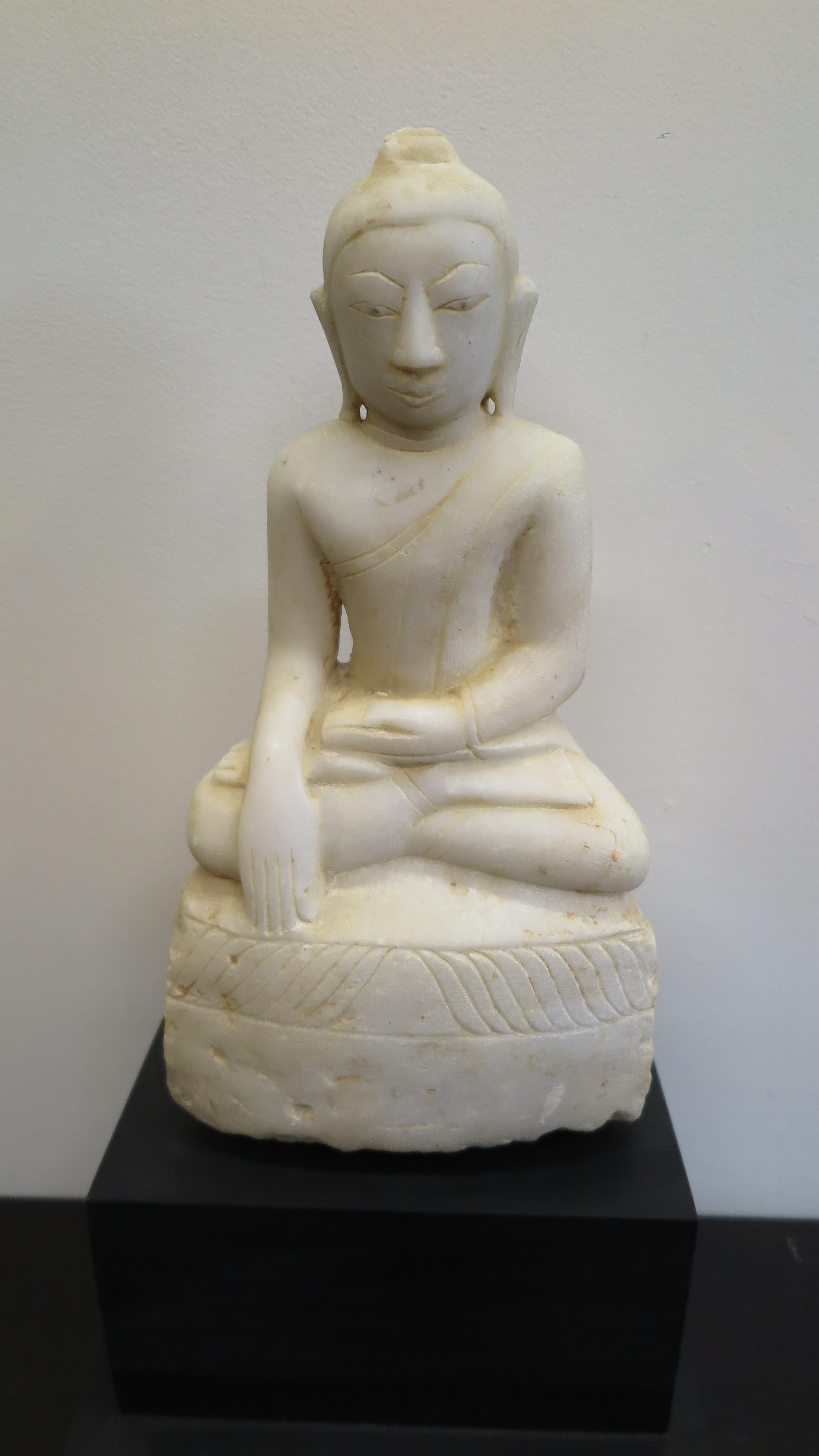 18th/19th century Buddha Statue carved of Alabaster. Burmese Shan Buddha Statue 1800ca, collected in Myanmar Shan State 1998. Legs crossed, the left hand in the lap, and the right hand pointing to the ground with the palm facing inward toward the