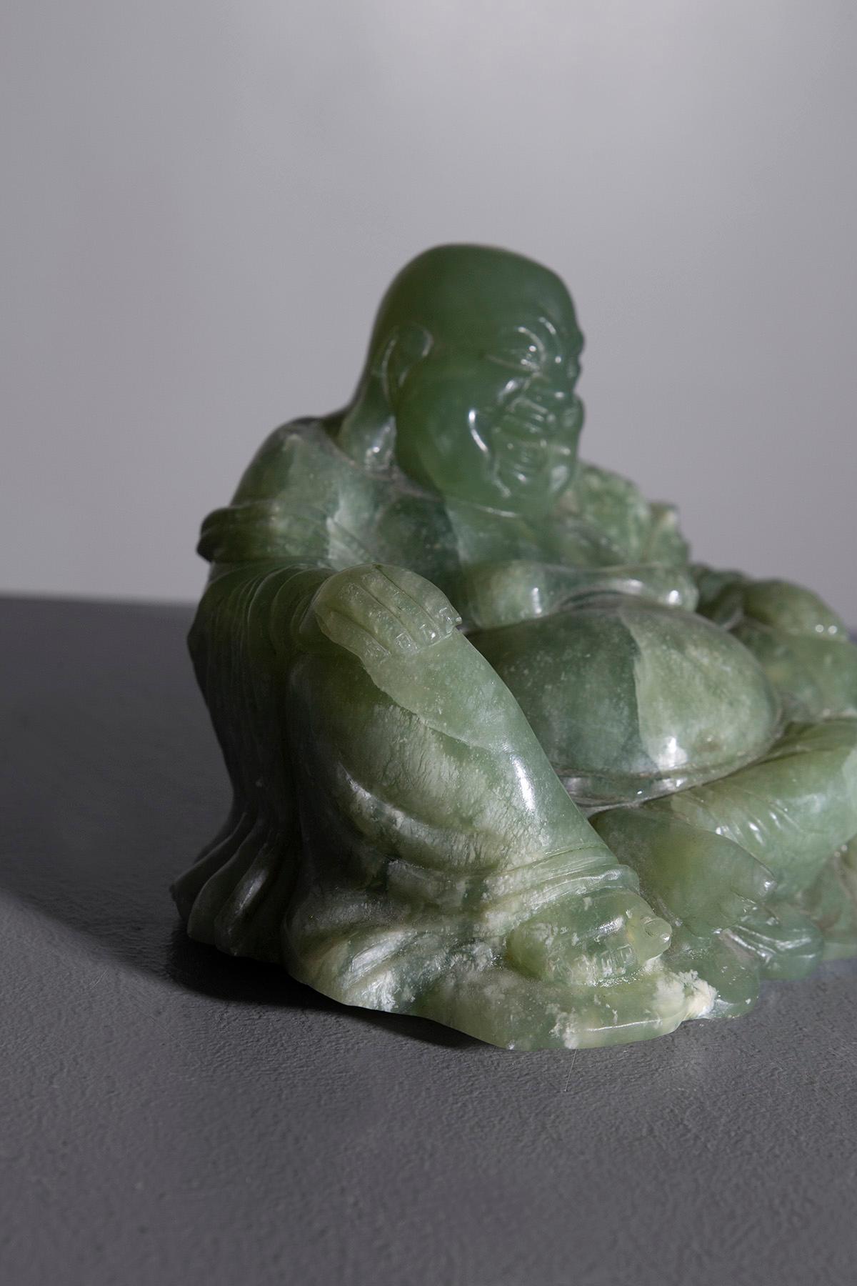 Dive into the serene world of spiritual art with this exquisite jade Buddha statue, dating back to the mid-20th century. Carved from the finest jade, this statue captures the essence of tranquility and harmony with its rich green color and expert