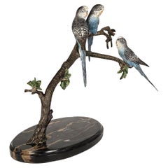 Budgerigars, Austrian bronze cold painted, three sat on a branch, circa 1930