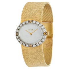 Montre Girard en or 18 carats sertie de diamants (cadran MOP)