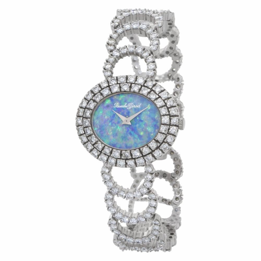 Colorful Australian Fire opal dial Bueche Girod diamond cocktail watch in 18k white gold with approx. 13.5 cts in diamonds. Manual. 31 mm case size. Ref 9801. Circa 1970s. Fine Pre-owned Bueche Girod Watch. Certified preowned Vintage Bueche Girod