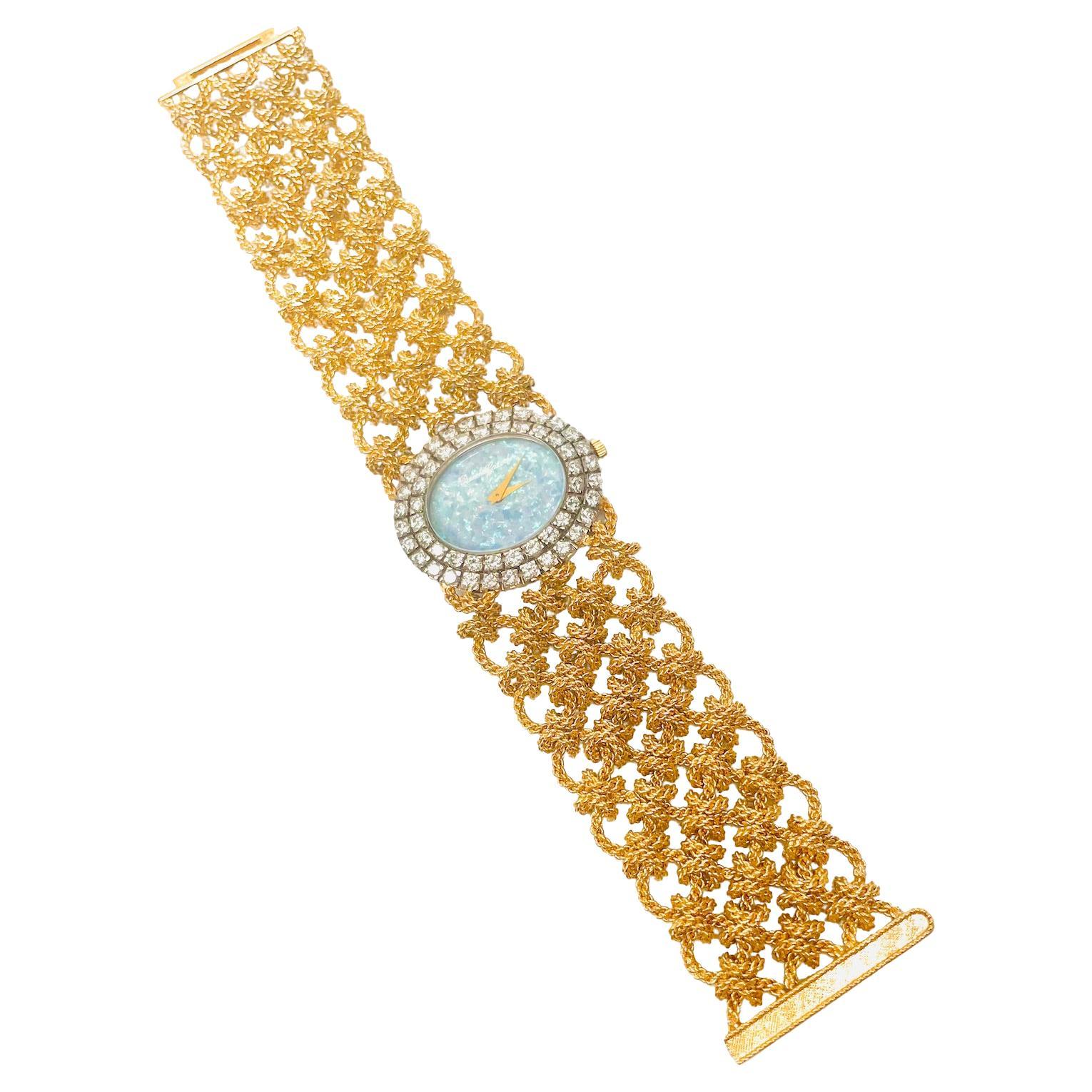 Bueche Girod Diamond, Opal, 18k Gold Watch. French made. 
This watch has an Oval shaped Opal Face measuring 20.5 mm x 17 mm. It is surrounded by two rows of Round Brilliant Full Cut Diamonds.  There are 54 Diamonds weighing approximately 2.45