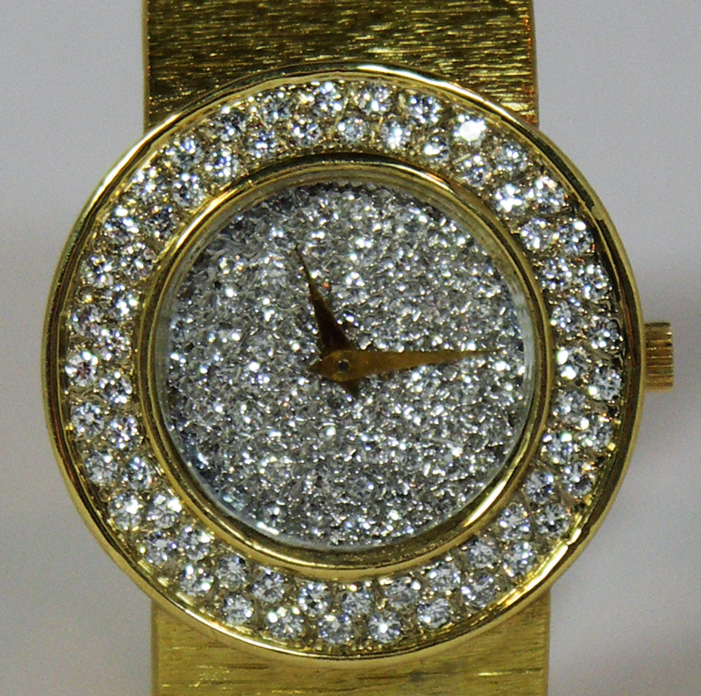 This elegant 18K yellow gold Bueche Girod is covered in diamonds both on the 
dial and the bezel. The total approximate diamond weight is 2.75ct of overall G/H
color and VS1 clarity. The round head measures 1 1/8
