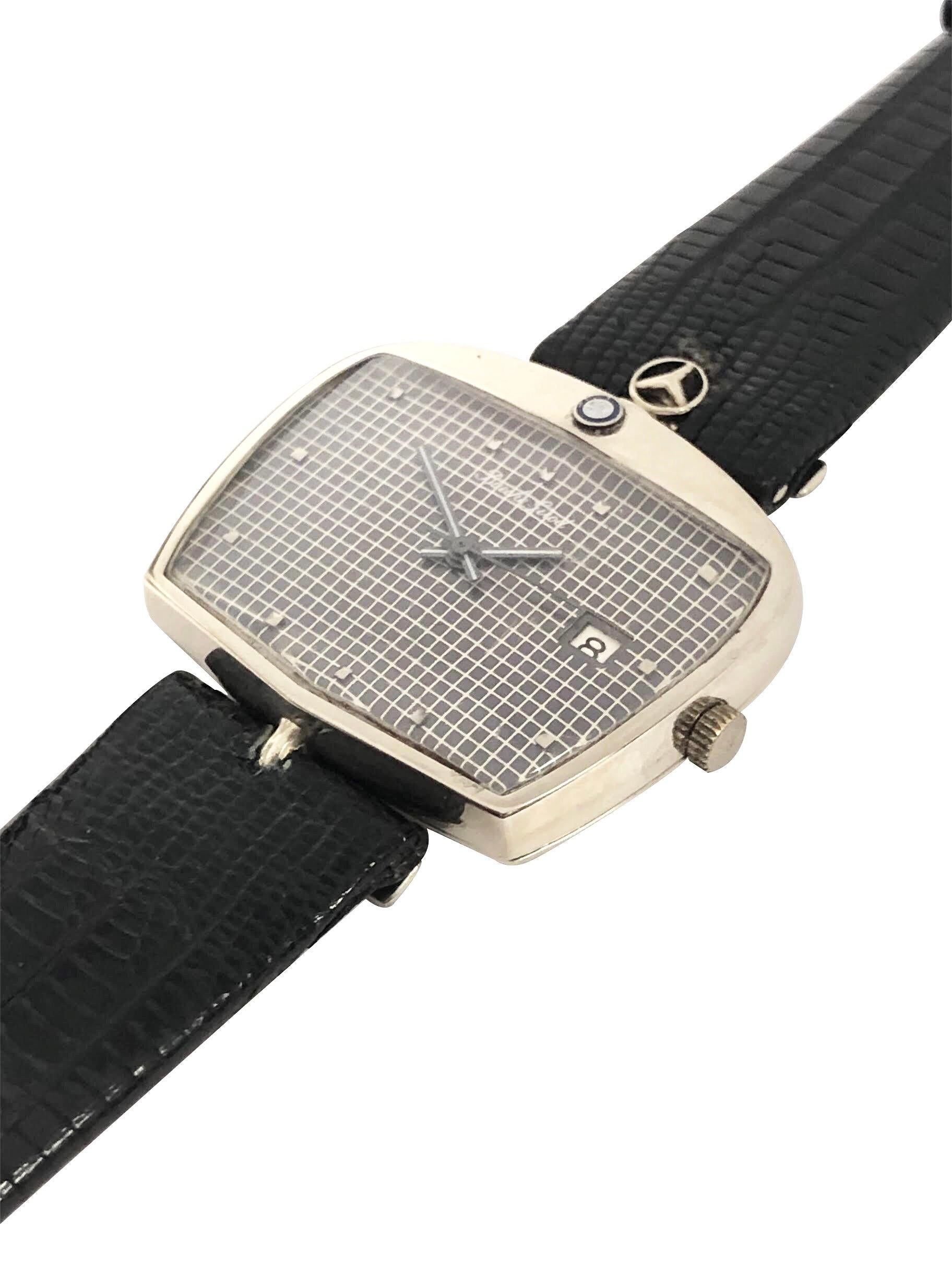 Circa 1970s Bueche Girod Extremely Rare Mercedes Benz Wrist Watch,  18K White Gold 29 X 37 M.M. X 8 M.M. thick 2 Piece Mercedes Benz Car Grill shape case with hood ornament. 17 Jewel Automatic, Self winding movement. Gray dial with Cross Hatch