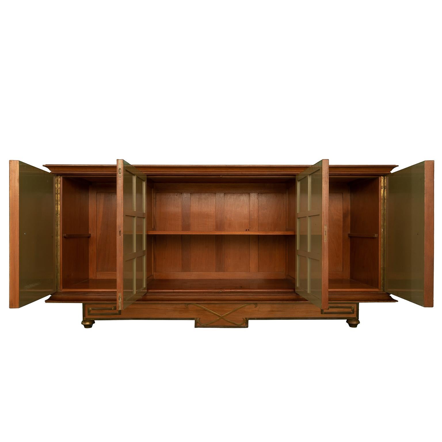 buffet cabinet, with golden doors and drawings of centaurs, Made of red cedar wood, it has surfaces with bronze. It is a Minimalist design of the 1950s.