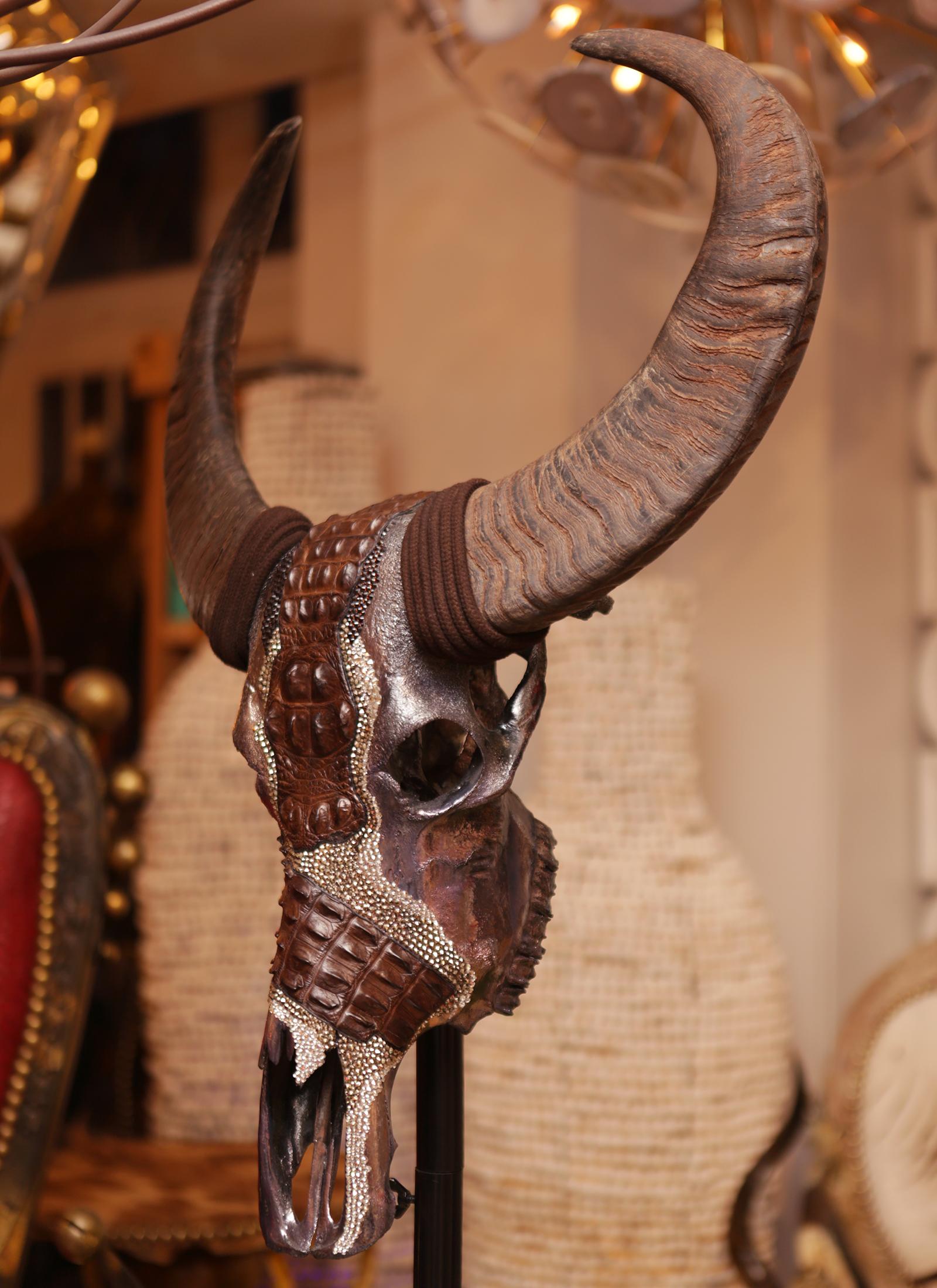 Sculpture buffalo croco made with real
Buffalo skull with horns. Skull is customized
In dark silver finish with carved shiny stones,
Brown tinted real crocodile skin. On forged
Metal base. Base height with skull included:
183cm. Exceptional and