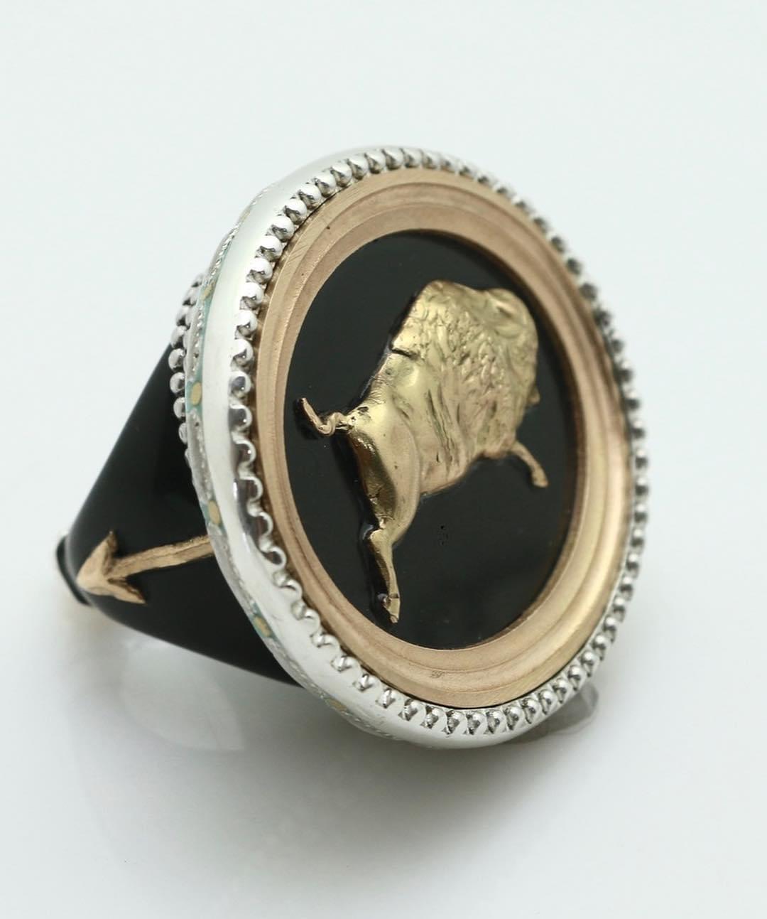 Contemporary Hand-Carved Buffalo Horn and Gold Ring with a Diamond and Enameled back.

Hand-carved buffalo horn large cocktail-style ring with 18k gold repoussé and a tiny diamond eye.  Stunning enameled underside with sterling silver and 18k arrow