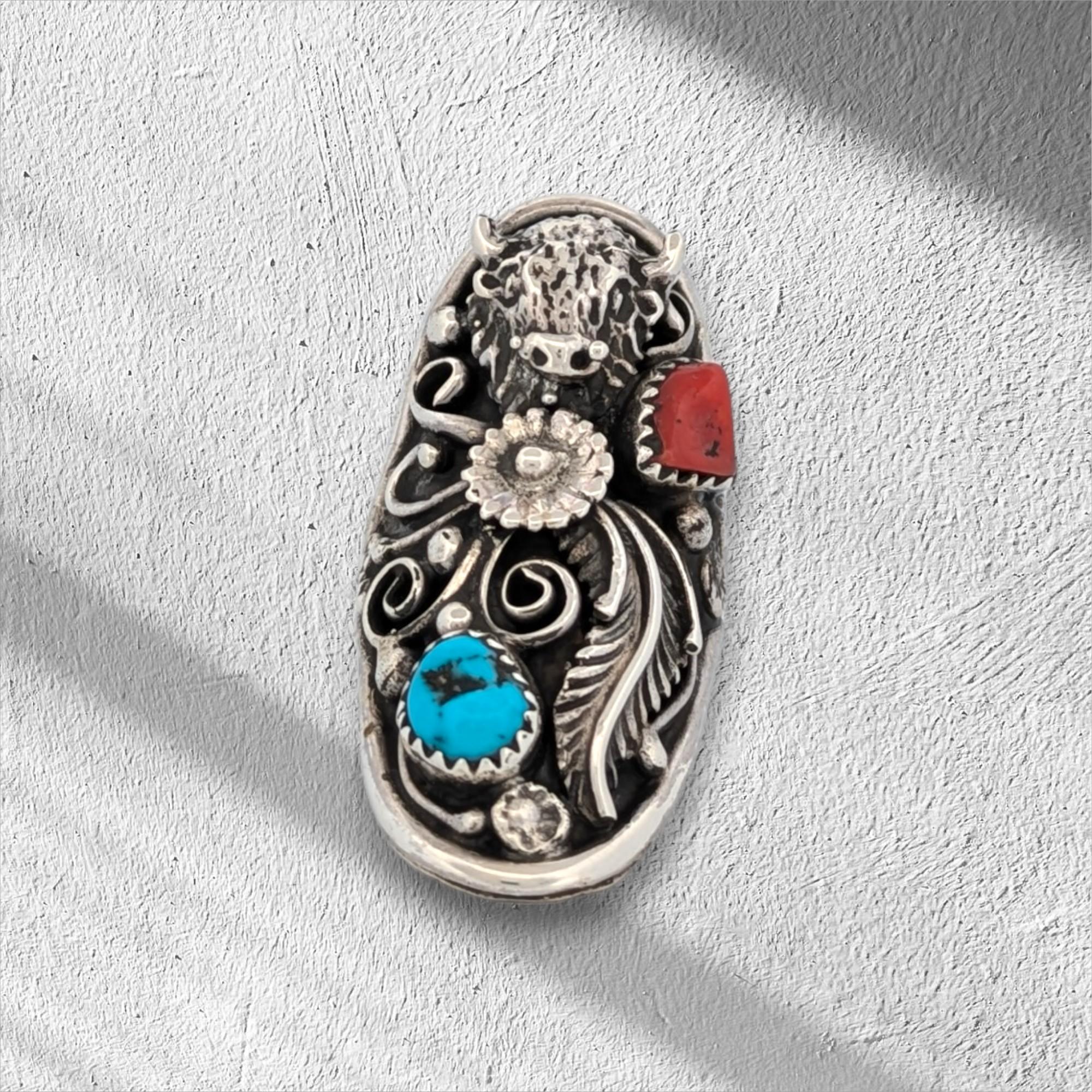 Zuni Artist Tammy Qudo's Handmade Sterling Silver Ring with Turquoise, Coral, & Buffalo, Flower, & Leaf Accents

Buffalo Run is a beautifully crafted Native American handmade sterling silver ring, adorned with intricate buffalo, flower, and leaf