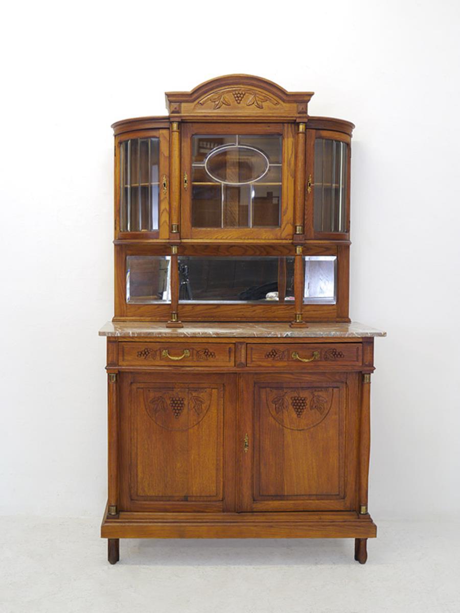Antique round arch buffet made, circa1920 from solid oak.
The cabinet can be dismantled in two parts consisting of attachment and base cabinet.
The three-door top is made of leaded glass doors, inside there is a shelf on each side.
The