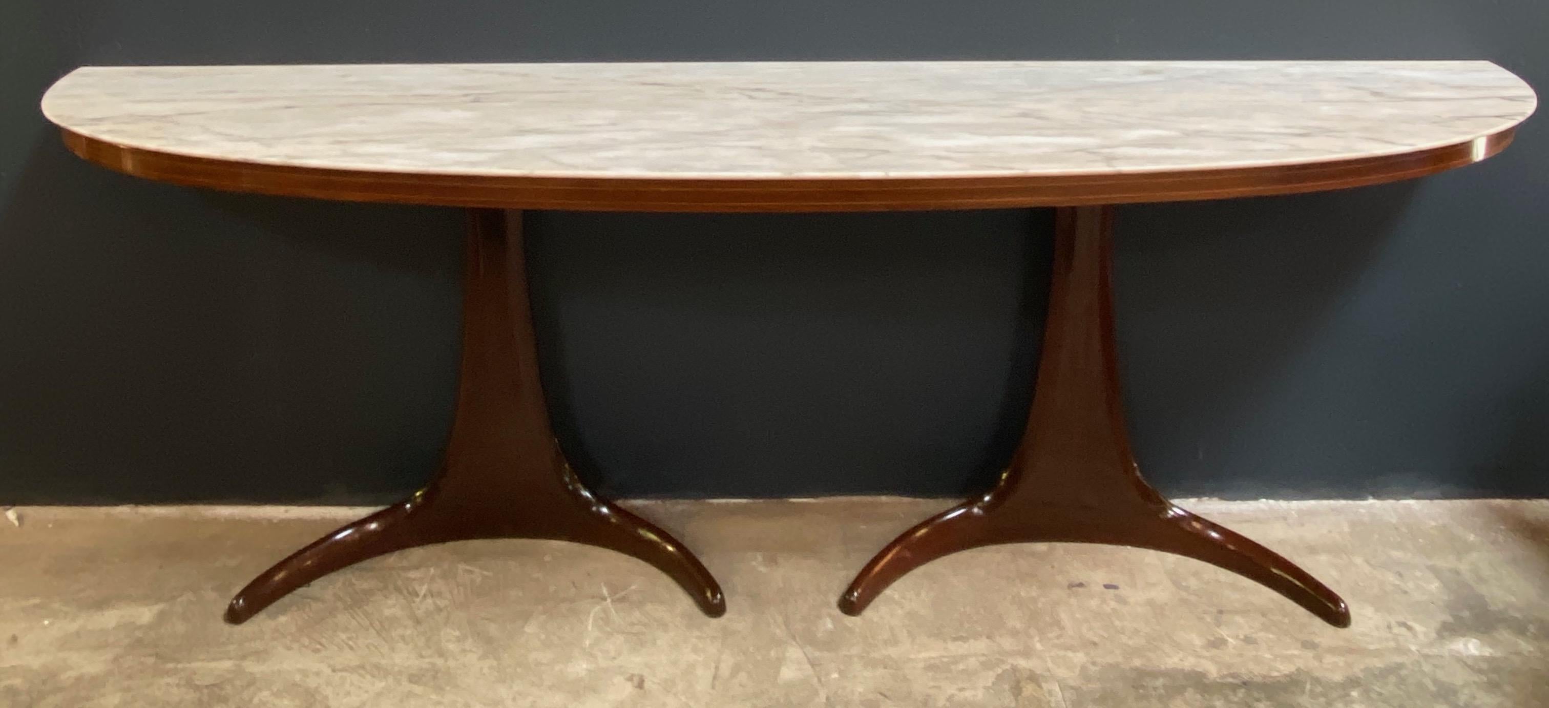 Buffet/console, in the style of Guglielmo Ulrich rosewood and marble, Italy, 1950s: two stunning wood round and cone shaped legs, connected to each other in curved wood and with its typical marble top give this console an extremely light and open