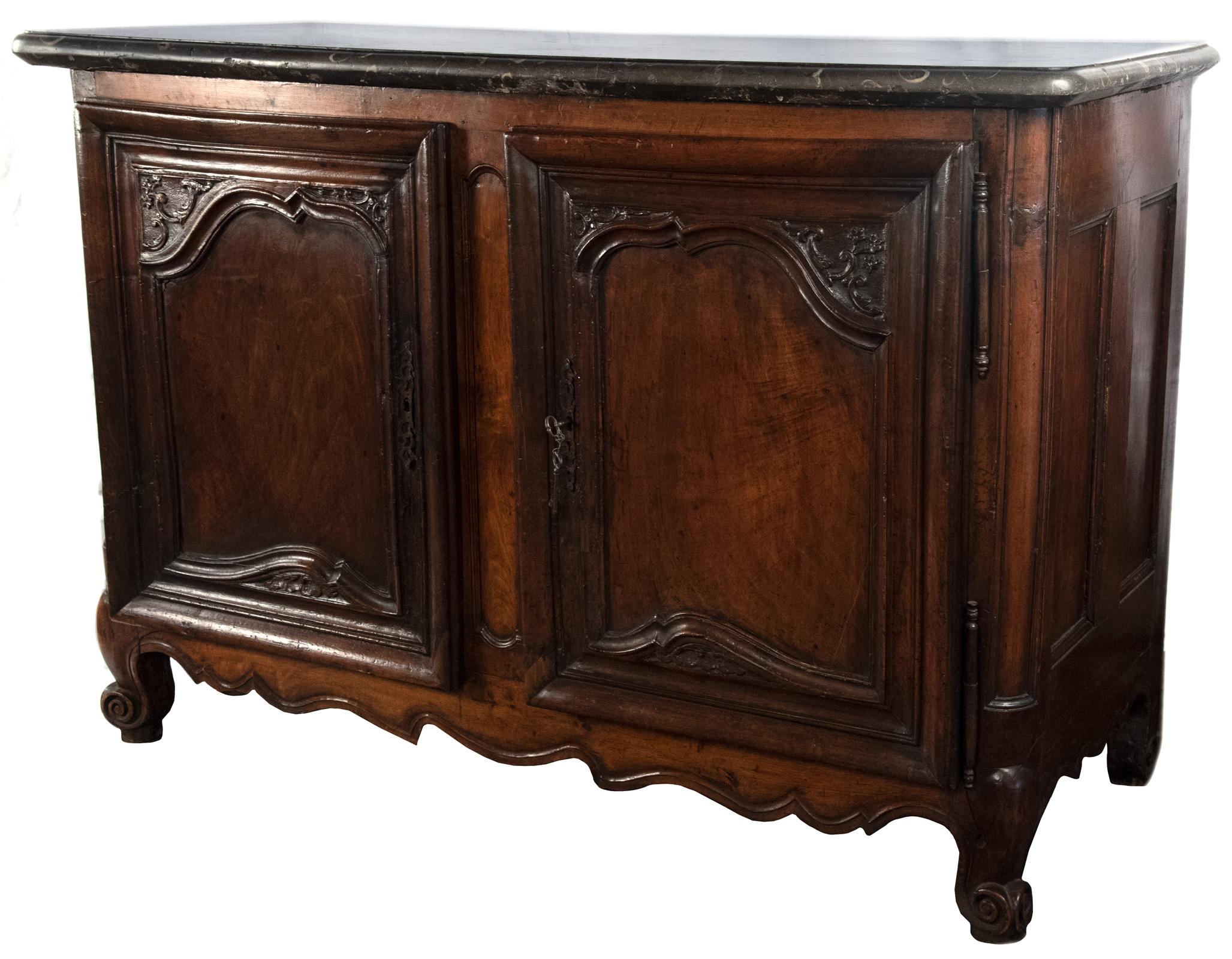 An 18th century French walnut buffet with original hardware and locks, topped with a thick marble stone that bears the marks of its use as a hunting cabinet, used for the processing of game.