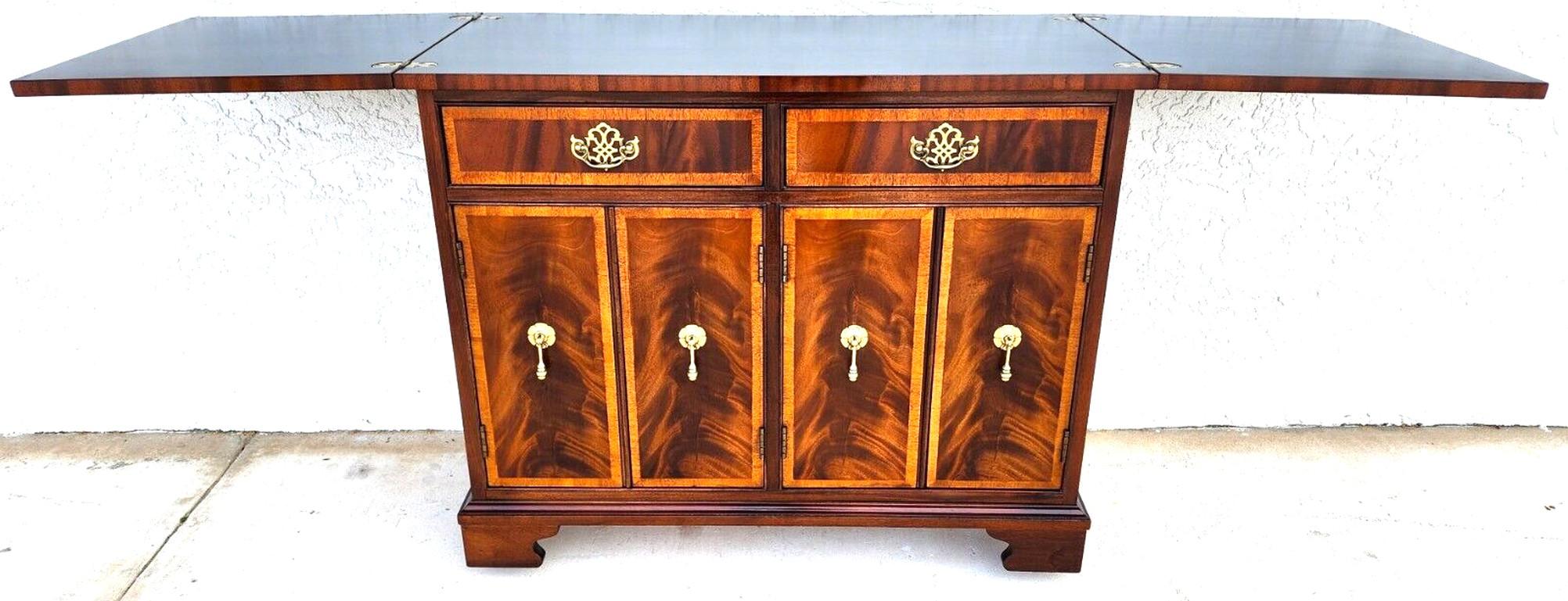 For FULL item description click on CONTINUE READING at the bottom of this page.

Offering One Of Our Recent Palm Beach Estate Fine Furniture Acquisitions Of A
Vintage Rolling Buffet Dry Bar Sideboard Fliptop Flame Mahogany by HICKORY WHITE
Featuring