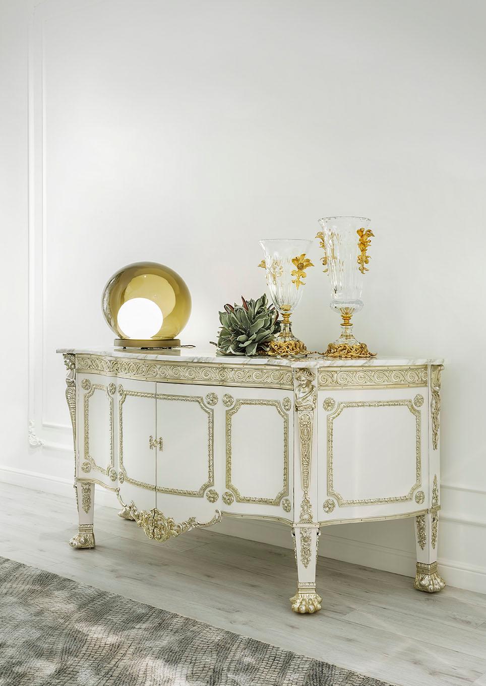 Buffet cabinet designed following some distinctive elements of the Empire 
style such as the applications of bronzes on the column legs, zoomorphic feet 
and friezes that frame the solid lime wood structure with the typical curved 
contrasting shape