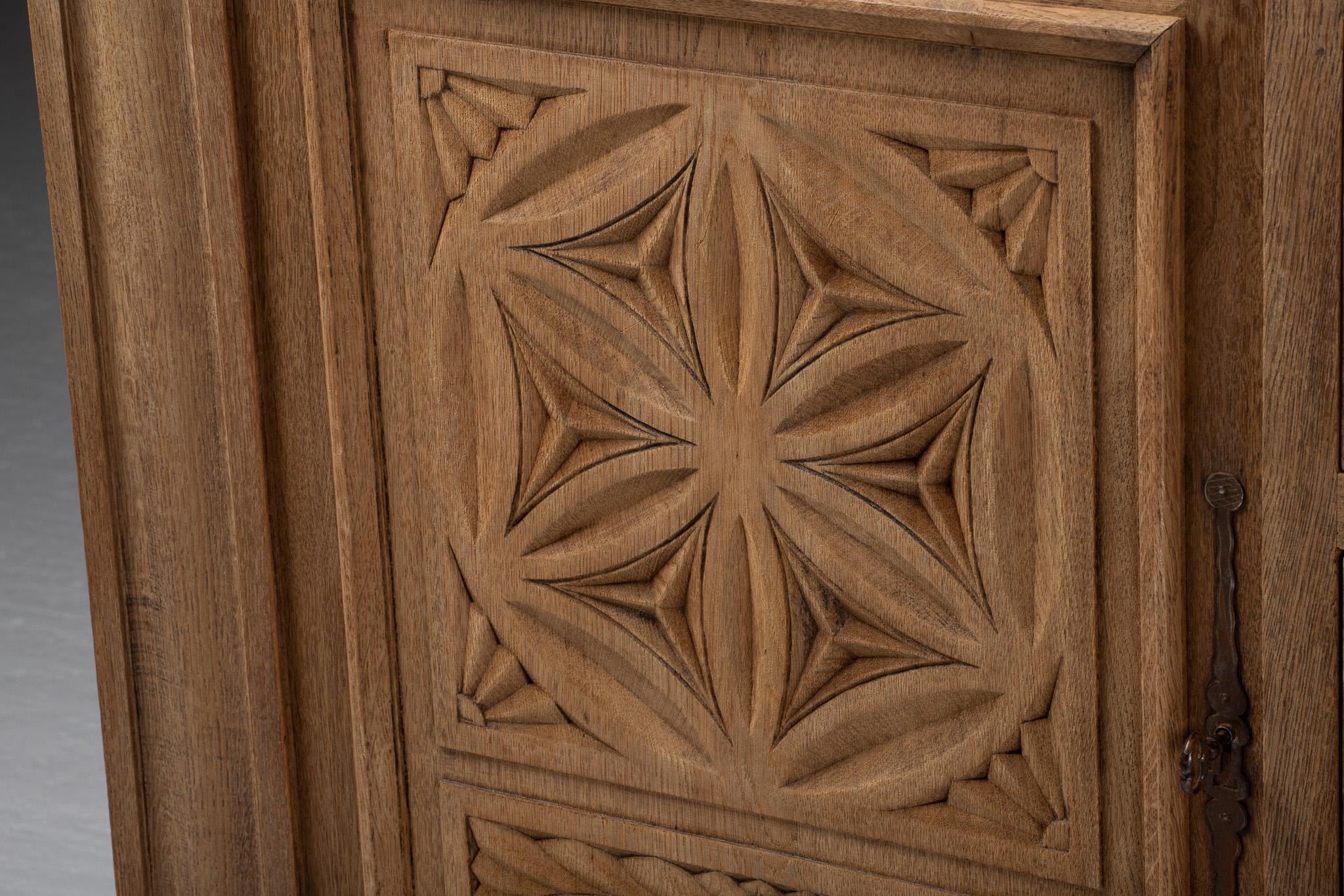 A procession of geometric medallions unfurls across the façade of this Spanish buffet, its surfaces etched with deep, rhythmic carvings that oscillate between order and ornament. Each motif—rosace, lozenge, and stylized flower—catches the light with