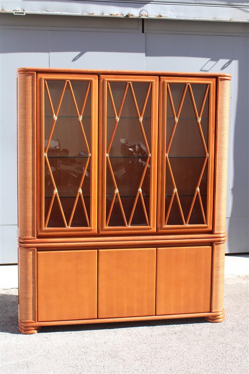 Showcase in bamboo wood and rattan Productions Roberti 1970 Made in Italy, 

Lower part three doors, upper part between glass doors with thickened glass shelves.