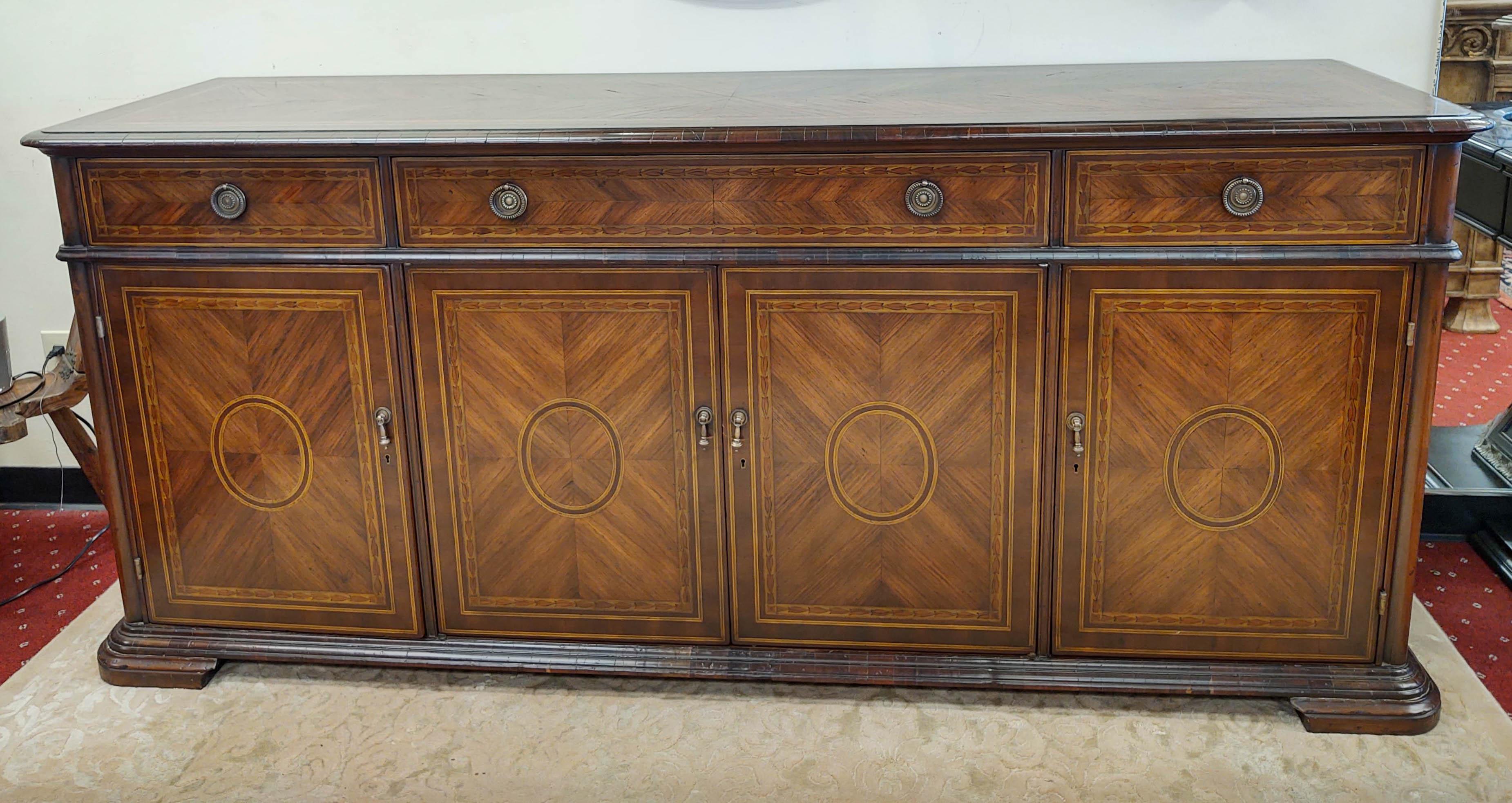 Beautiful marquetry inlaid buffet finished with solid hand-poured brass hardware.  Much of the beauty of this collection is the pedigree of design, the craftsmanship, and the unique character of each piece. Alfonso Marina began in 1971 as an artist