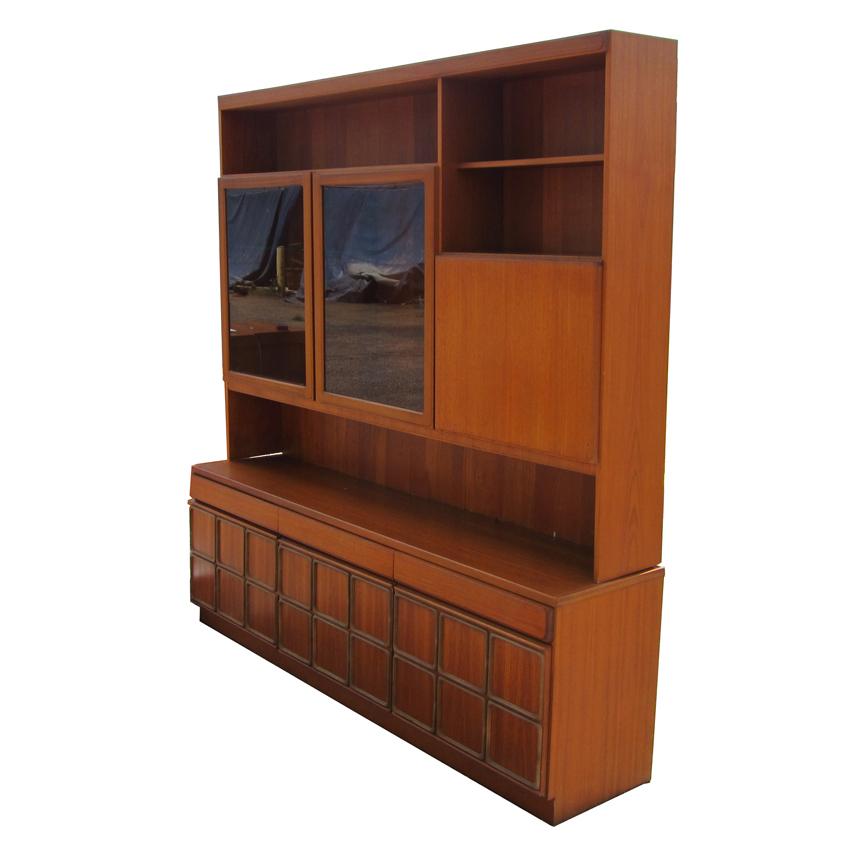 A great  Mid Century Modern credenza with a display cabinet. The display cabinet has a drop-down, leather-inset cabinet with a mirrored back, as well as several open cabinet spaces and two glass-fronted cabinets. The credenza comes with two