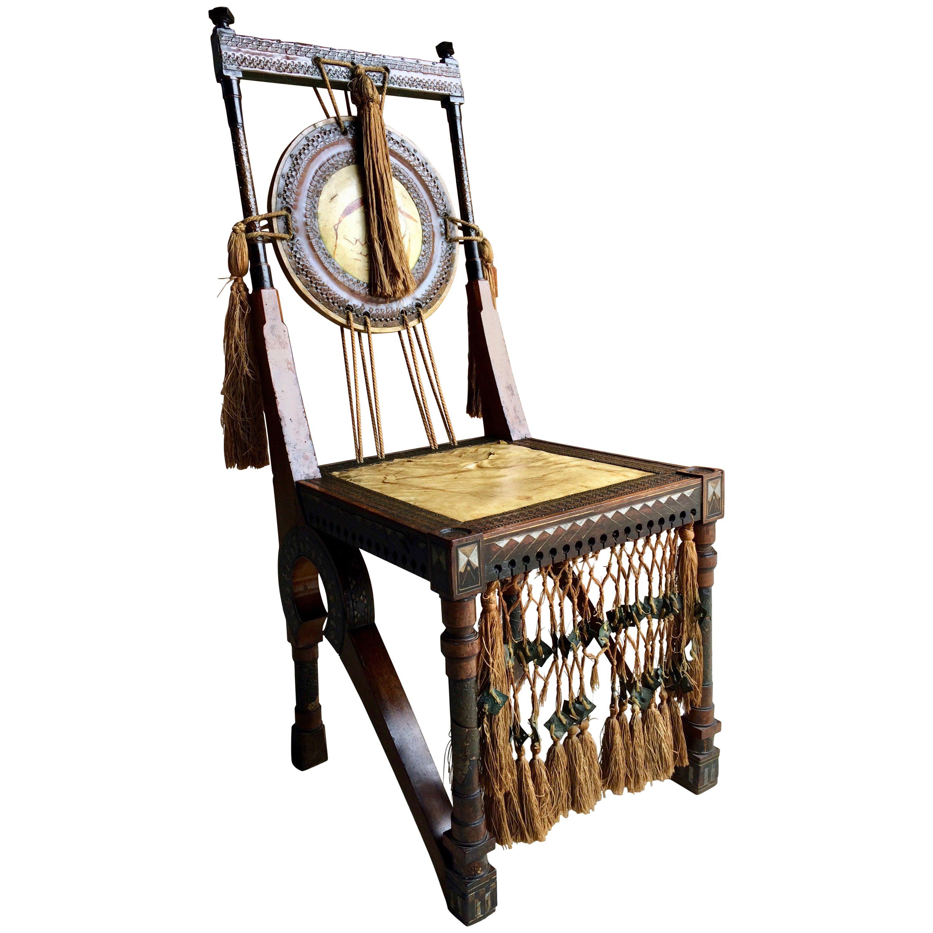 Carlo Bugatti (1856-1940) side chair made from walnut with embossed copper and pewter inlay, velum seat and back painted with stylised flora with original silk tassels, circa 1900.

Background:

Carlo Bugatti was an Italian furniture designer