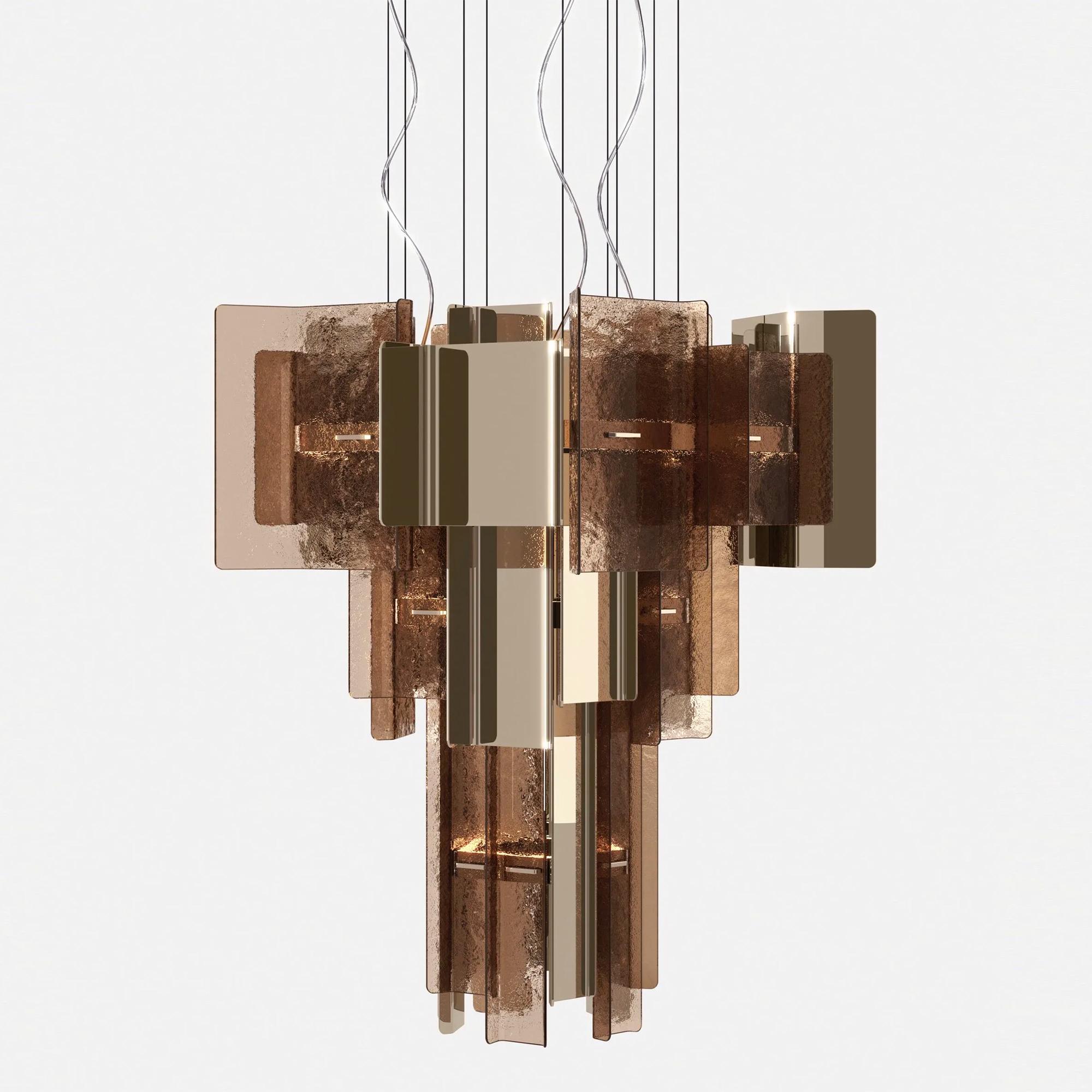 Edificio a sospensione Vetro bronzato con parti in metallo in 
finitura champagne e con parti in vetro fuso in bronzo 
finitura. Illuminazione a LED 3000K, dimmerabile. Con sistema di regolazione 
Cavi di sospensione in acciaio, fino a 4 metri, con