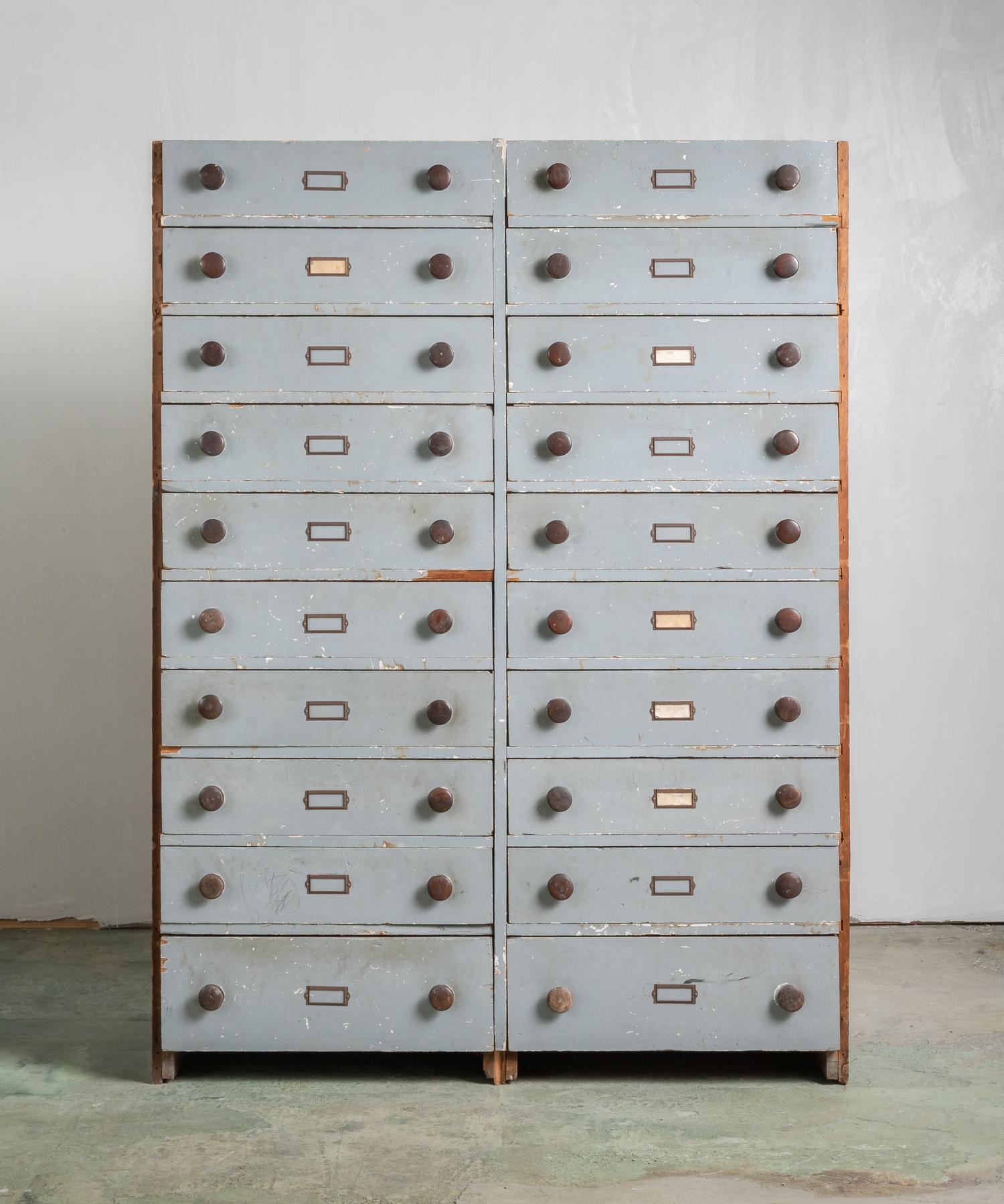 Built-In archival bank of drawers, America, circa 19th century.

Incredible, simple form in original paint, circular pulls and amazing patina. Originally built into a home from the South Shore of Massachusetts.