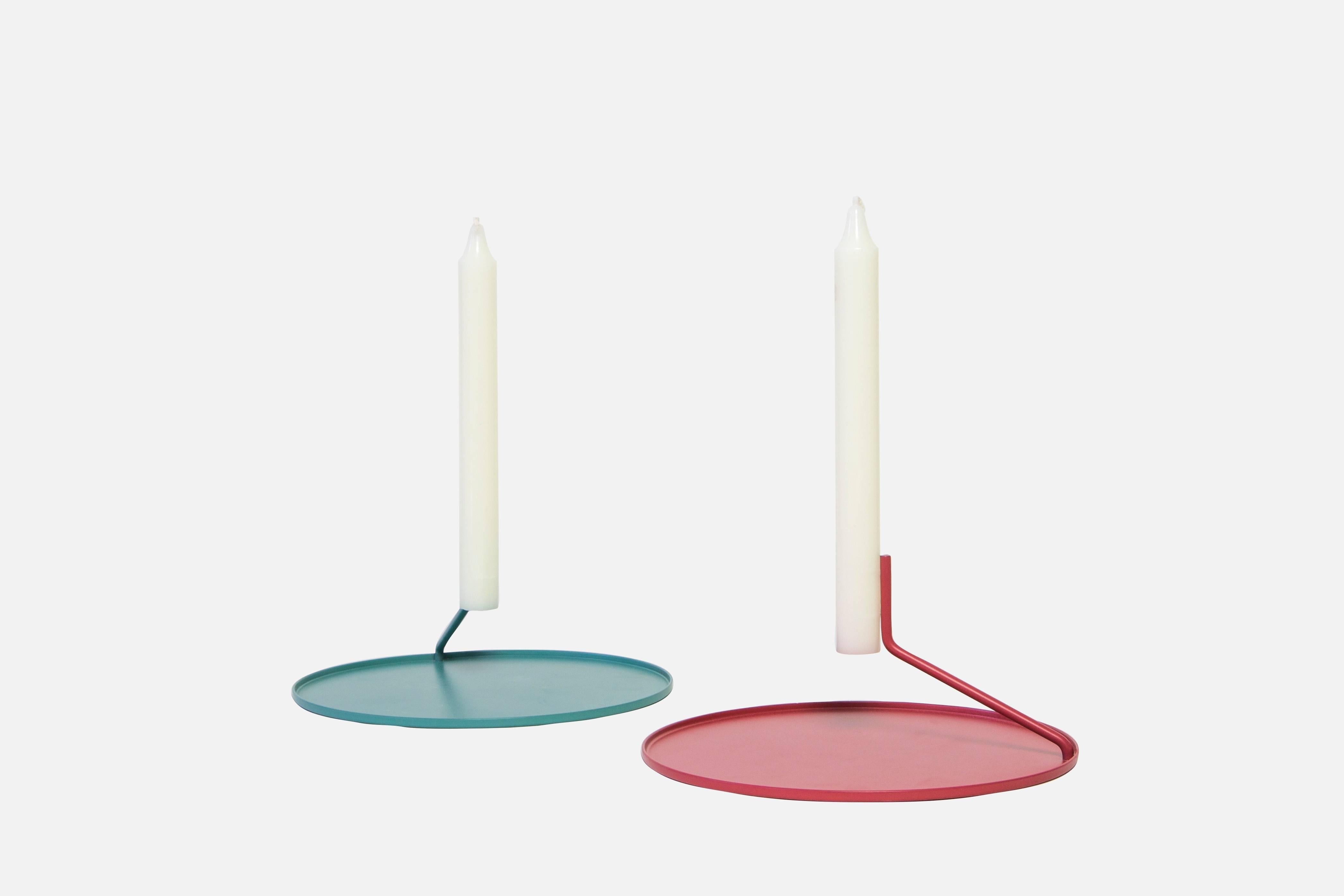 This listing includes our Buka candlestick in red with five white candles.

Simple, elegant and mysterious, the Buka candlestick uses two pins to suspend a candle above a metal dish - giving it the appearance that it's levitating. Minimal, yet