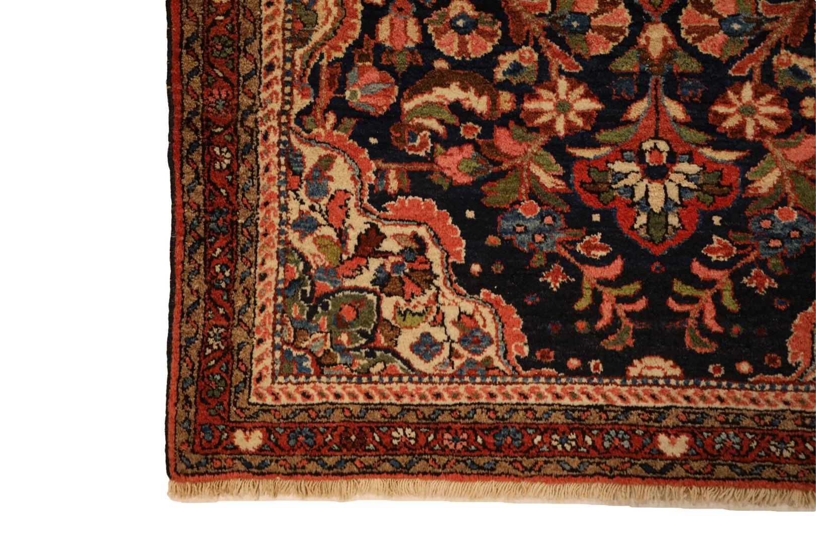 The Bukharlu-Hamedan Navy Rug is a testament to the artistry and craftsmanship of rug-making. Its captivating color scheme draws the eye with a navy background that exudes sophistication. Against this backdrop, an enchanting blend of red, pink,