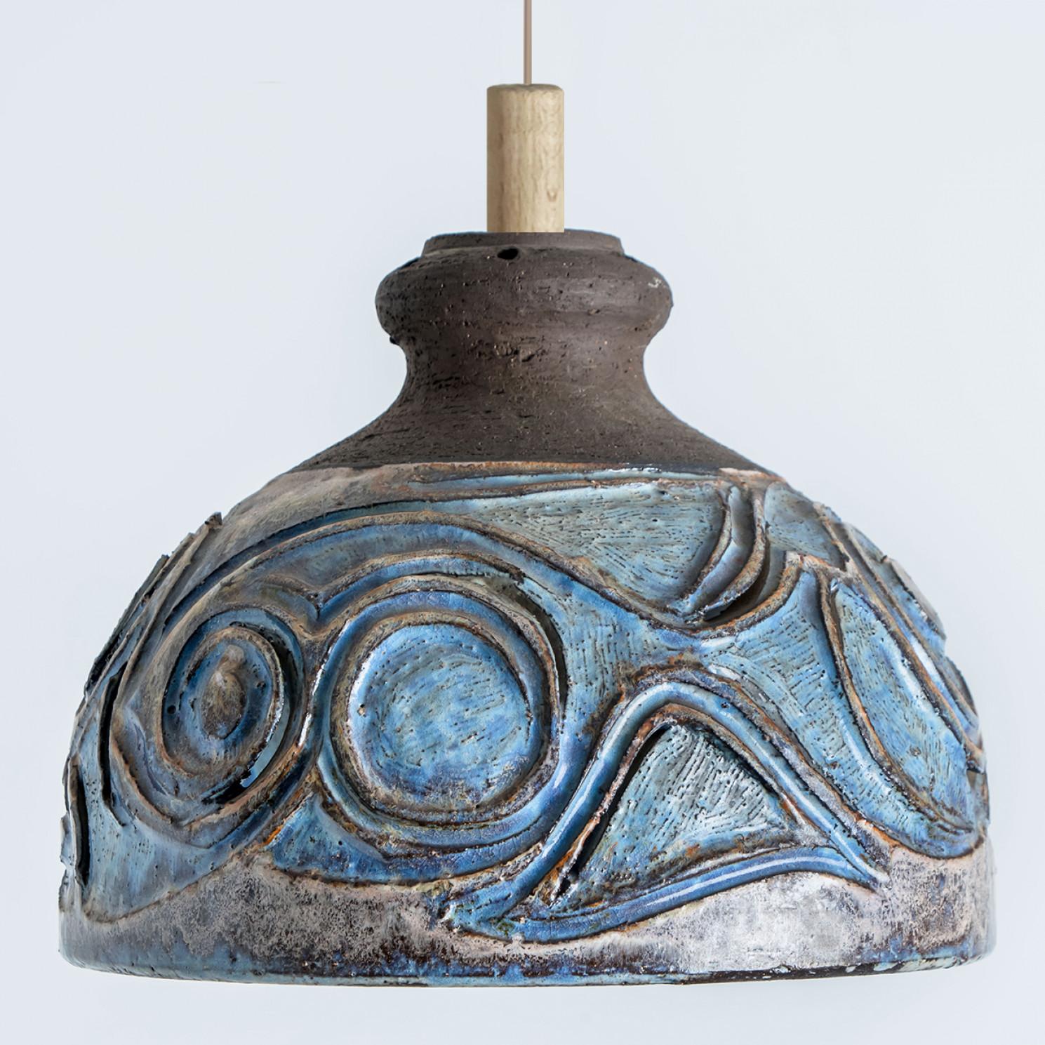Stunning round hanging lamp with an unusual shape, made with rich brown and light blue colored ceramics, manufactured in the 1970s in Denmark. We also have a multitude of unique colored ceramic light sets and arrangements, all available on the