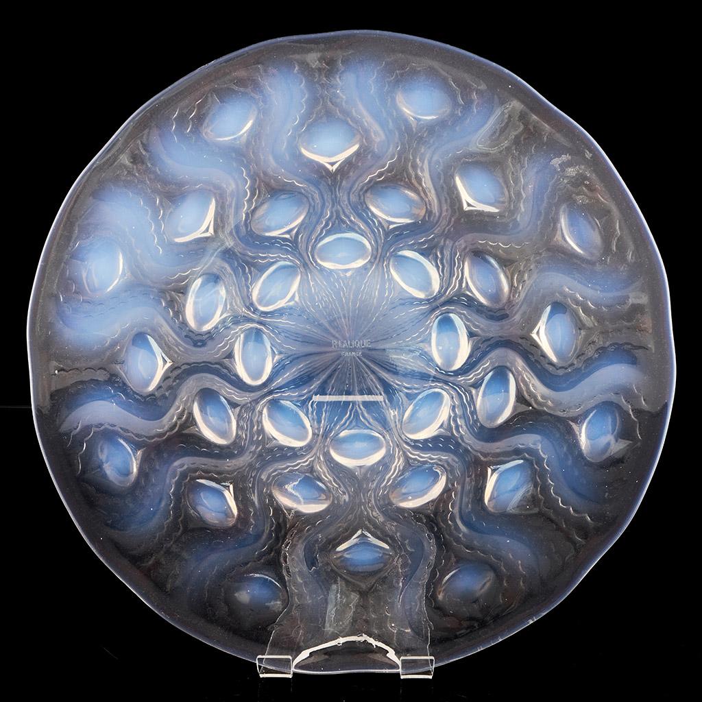 Bulbes, an Art Deco opalescent and frosted glass plate by René Lalique with stylised bulbs design. Stencil etched R Lalique France to centre.

René Jules Lalique (French, 1860–1945) was a renowned jeweller and master glassmaker. As one of the
