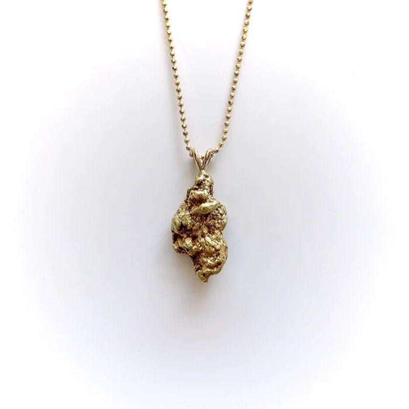 This 22k gold nugget pendent features a beautiful display of gold in its natural, unaltered state. The free form dimensions of the nugget are organic and poetic, highlighting the buttery gold and extraordinary crevices. The shape is bulbous, and the