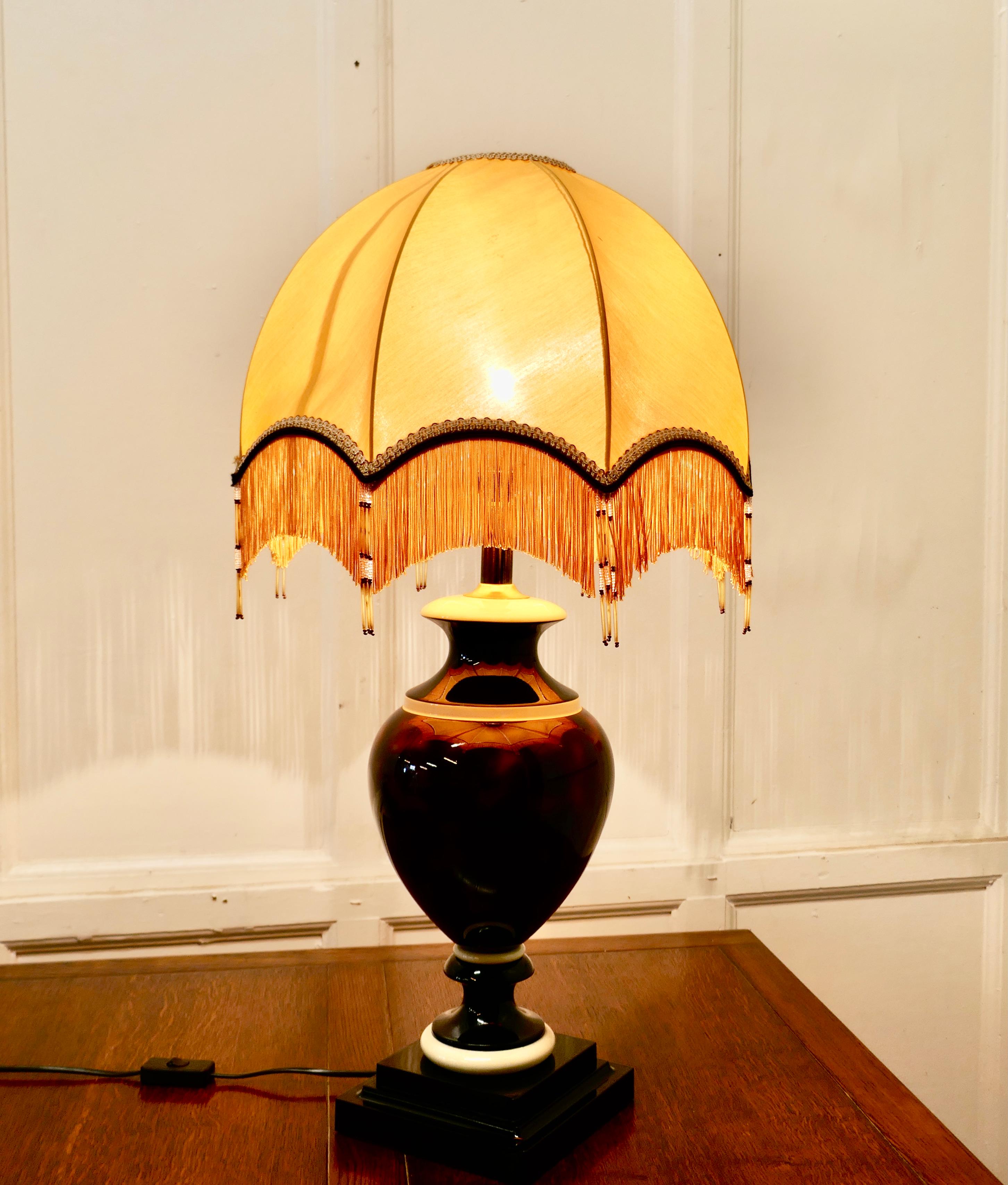 Bulbous ceramic French table lamp with dome lampshade

The lamp has a large ceramic urn which is decorated as simulated tortoiseshell, it is topped of with a superb large dome lampshade 
The lamp and shade are in good used condition, the wiring