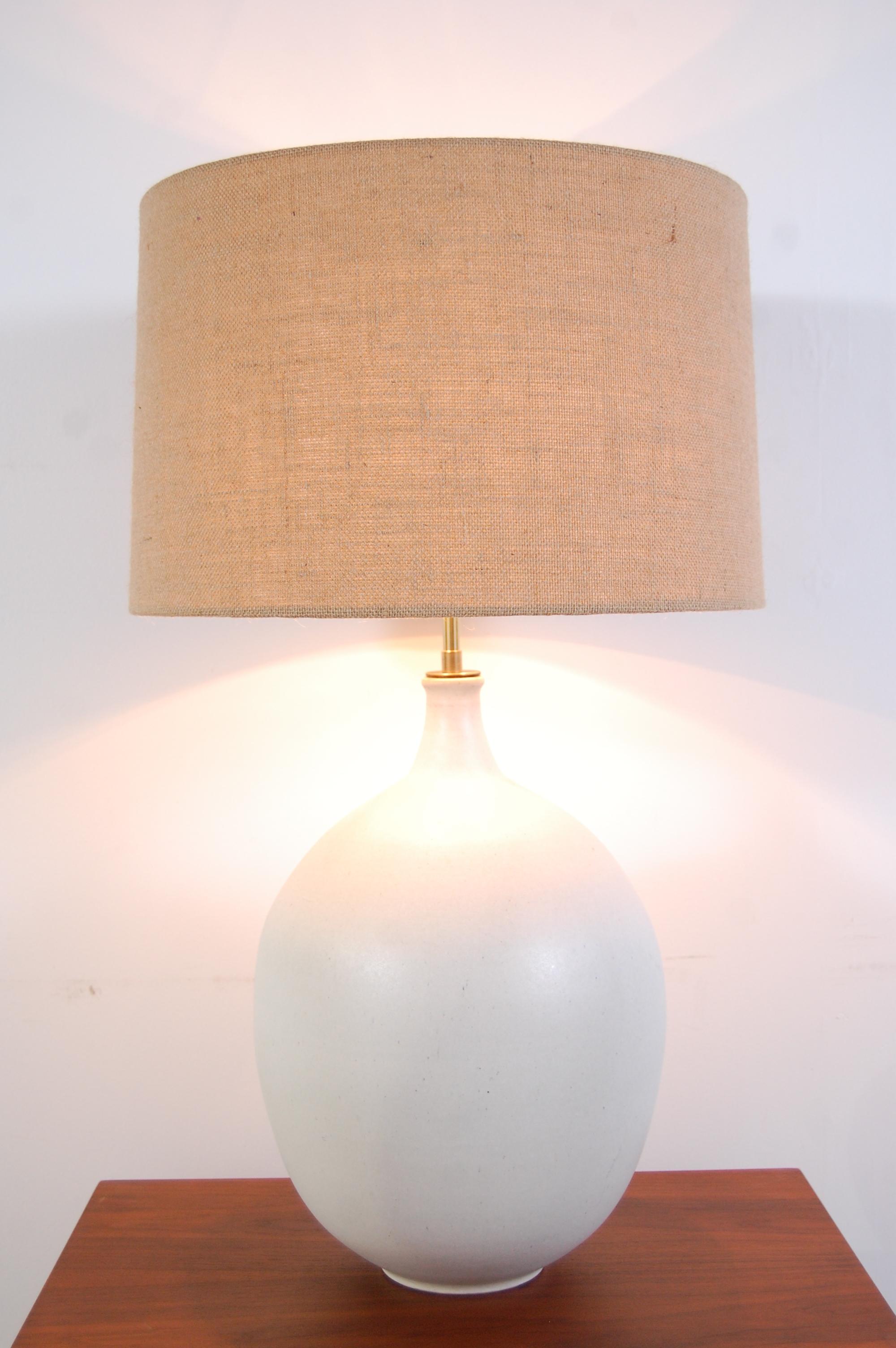 Design Technics pottery lamp, by Lee Rosen, circa 1966. Lamp body has a wonderful, bulbous form, with a magnesium white glaze. Lamp has been completely re-wired for safety, as all vintage lighting should be, and top quality, solid brass hardware has