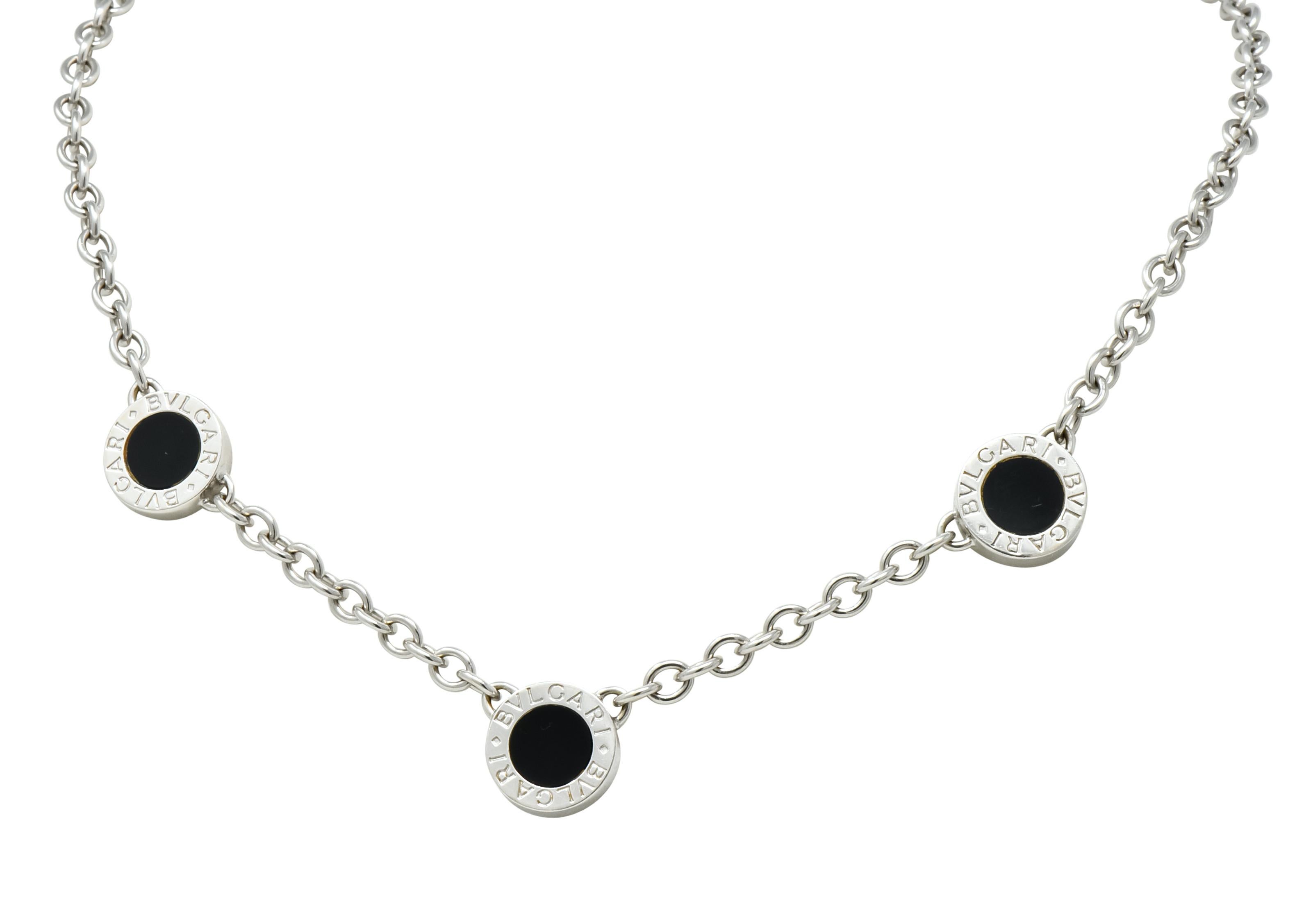 Necklace comprised of white gold cable chain with three, front facing, disk stations 

Stations are inlaid on one side with smooth circles of black onyx, while opposing side is pavé set with round brilliant cut diamonds weighing approximately 1.15