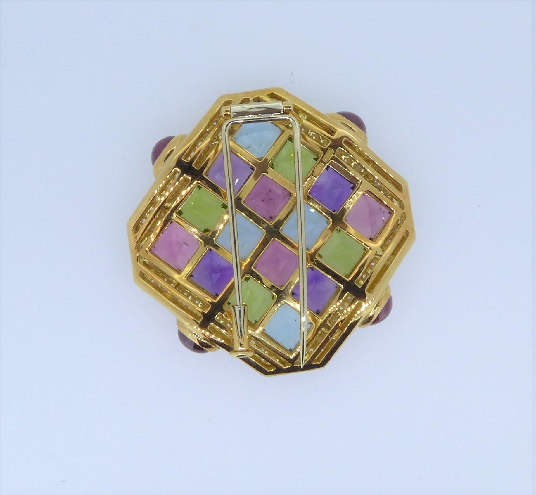 A Bulgari 18 Carat Yellow Gold Multi-Gem And Diamond Carré Brooch. 
The square shaped brooch adorned with amethyst, topaz, citrine and tourmalines within a diamond border. Signed 'Bulgari' '750' and numbered. Weighs approximately 37.4 grams and