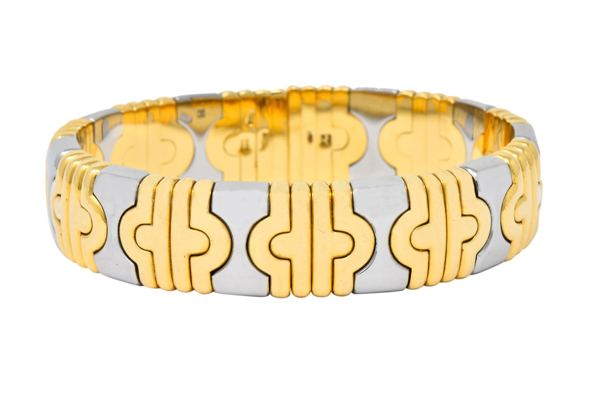 Cuff Bangle bracelet made with tubogas technology in the Or Et Acier style

Comprised of polished gold links in a ribbed geometric motif alternating with polished stainless steel links
 in an hour glass motif

From Bulgari's Parentesi