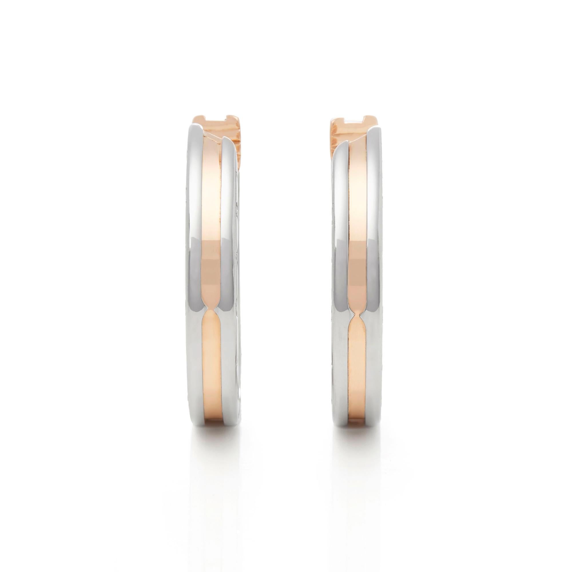 These Earrings by Bulgari are from their B.Zero 1 collection and features their signature Bulgari logo, made in 18k Rose Gold & Stainless Steel. These Earrings have secure latch backs. The total weight is 15.88 grams. Complete with Bulgari Box. 


