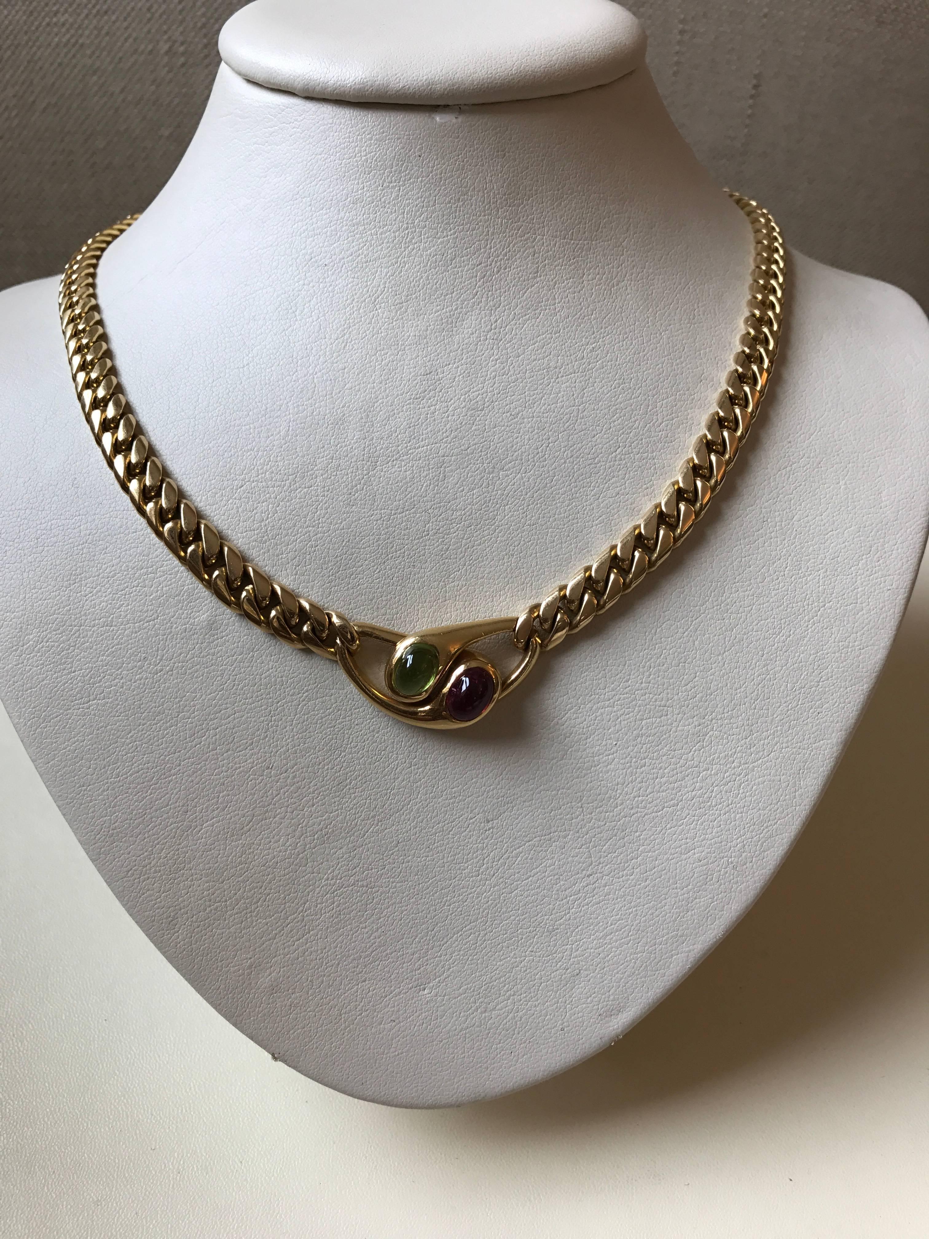 18ct yellow gold curb link necklace with central cabochon pink tourmaline and cabochon peridot feature signed by Bvlgari, circa 1990

Overall length of necklace 41cms