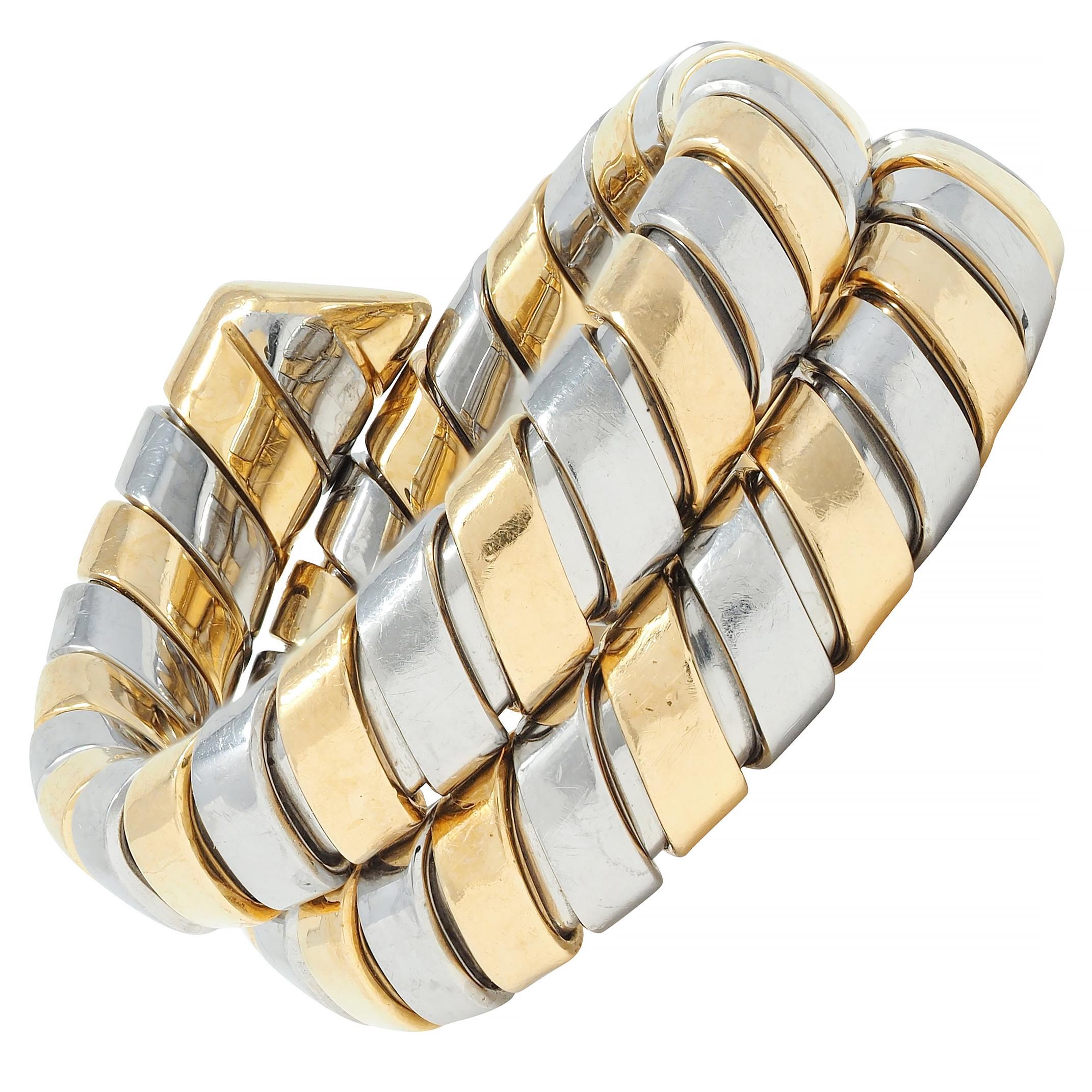 Designed as a triple wrap style ring comprised of segmented tubogas
Segments are high polished stainless steel and yellow gold 
With considerable flex
Stamped with Italian assay marks for 18 karat gold 
Tested as stainless steel
Numbered and fully