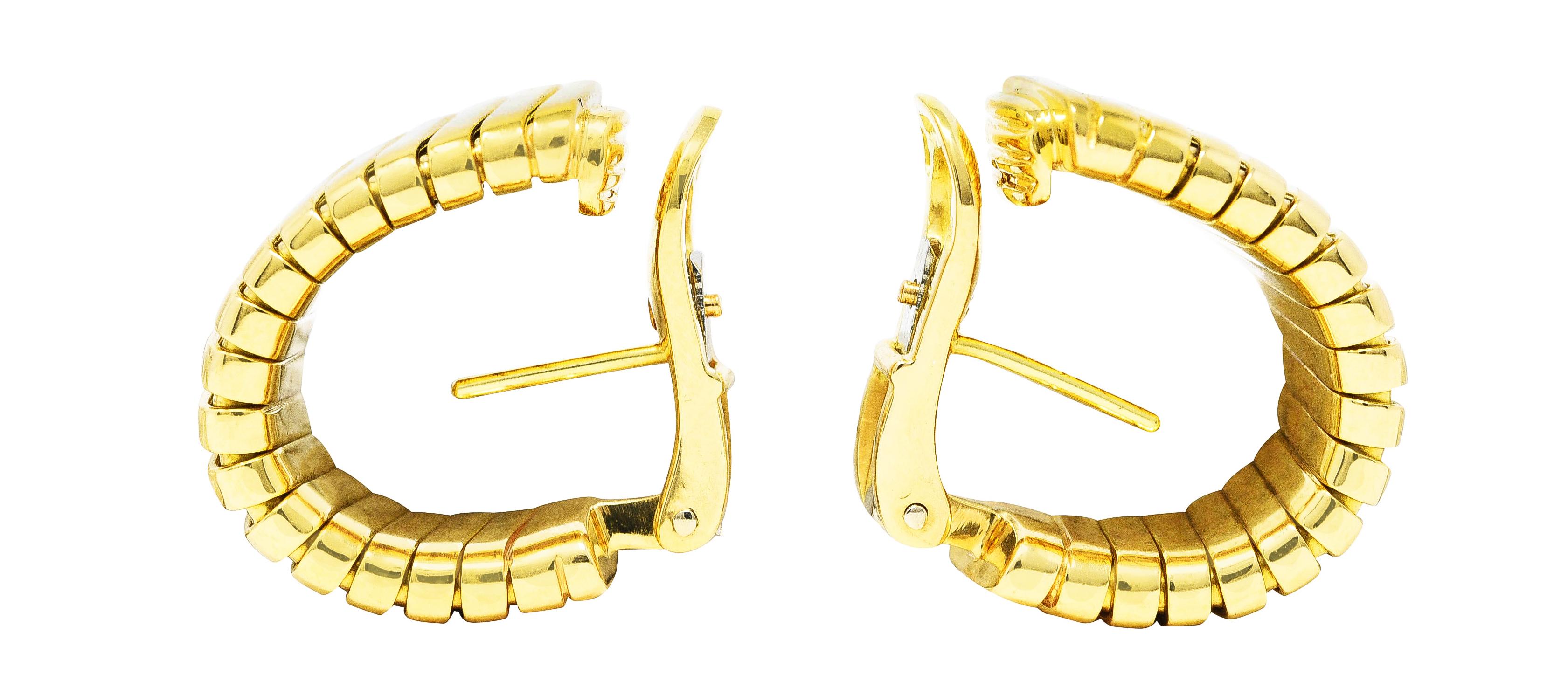 J hoop style earrings are designed as rounded tubogas. Deeply ridged and graduating in size. Completed by posts with hinged omega backs. Stamped 750 with Italian assay marks for 18 karat gold. Fully signed Bulgari, Made in Italy. 
Circa: 1980's.