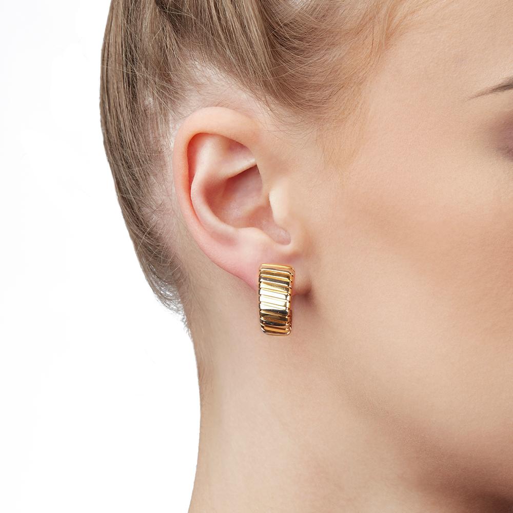 These Earrings by Bulgari are from their Tubogas collection and feature their signature Tubogas design, made in 18k Yellow, White & Rose Gold. The size is 2.3cm x 1.2cm. The total weight is 23.16 grams. These Earrings have secure lever backs and are