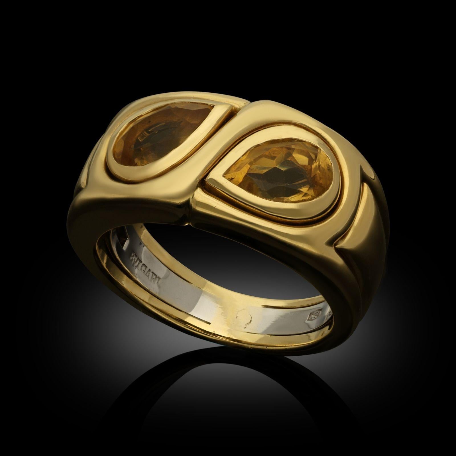 A vintage 18ct gold and citrine dress ring by Bulgari, circa 1980s, the ring of stylised ‘Toi et Moi’ design set to the front with a matched pair of pear-shape yellow citrines set horizontally within a wide tapering band of yellow gold, the gems