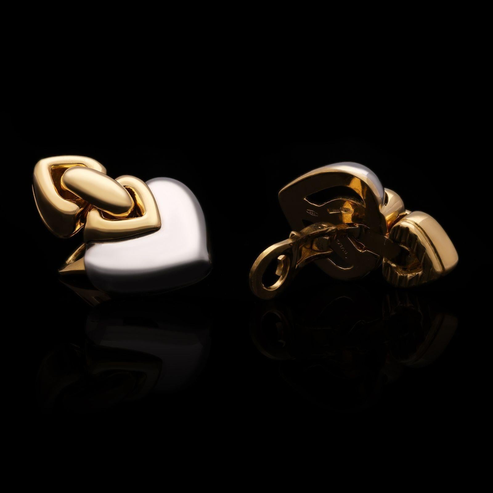 A pair of vintage gold and stainless steel ‘Doppio Cuore’ earrings by Bulgari c.1990s, formed of a stainless steel heart shaped motif inlaid to the top with a smaller one in gold joined to a second gold one inverted above it, with clip fittings to