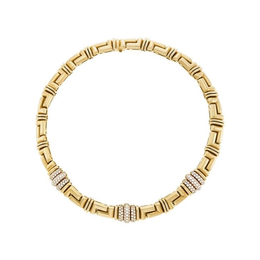 Bulgari Gold and Diamond Necklace
18 kt yellow gold, the polished articulated interlocking L-shaped links joined by pairs of bar links, centering bombé panels pavé-set with 189 round diamond ap. 4.50 cts., signed Bulgari, ap. 97 dwts. Length 15